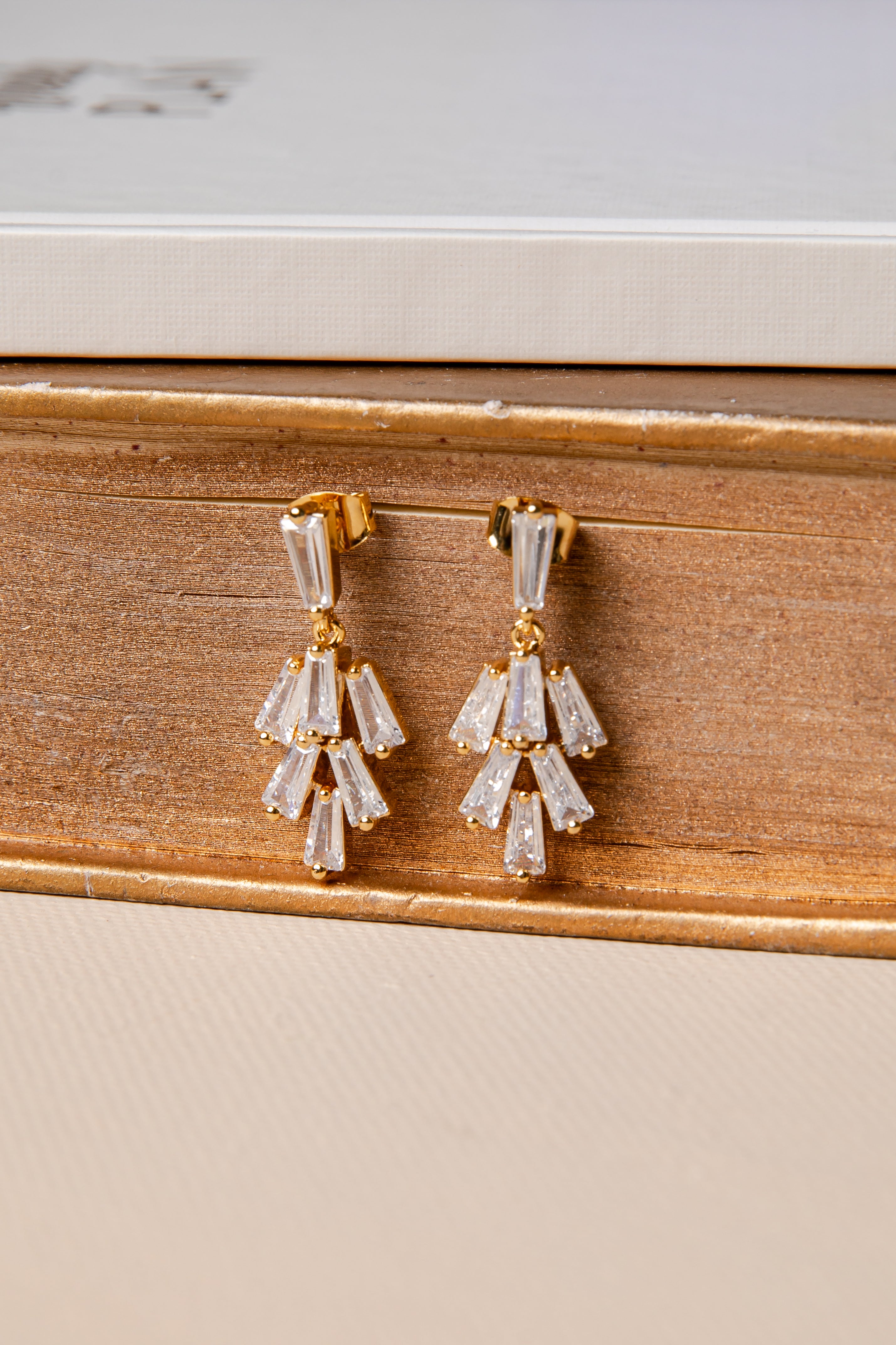 Pair of diamond earrings on a wooden surface