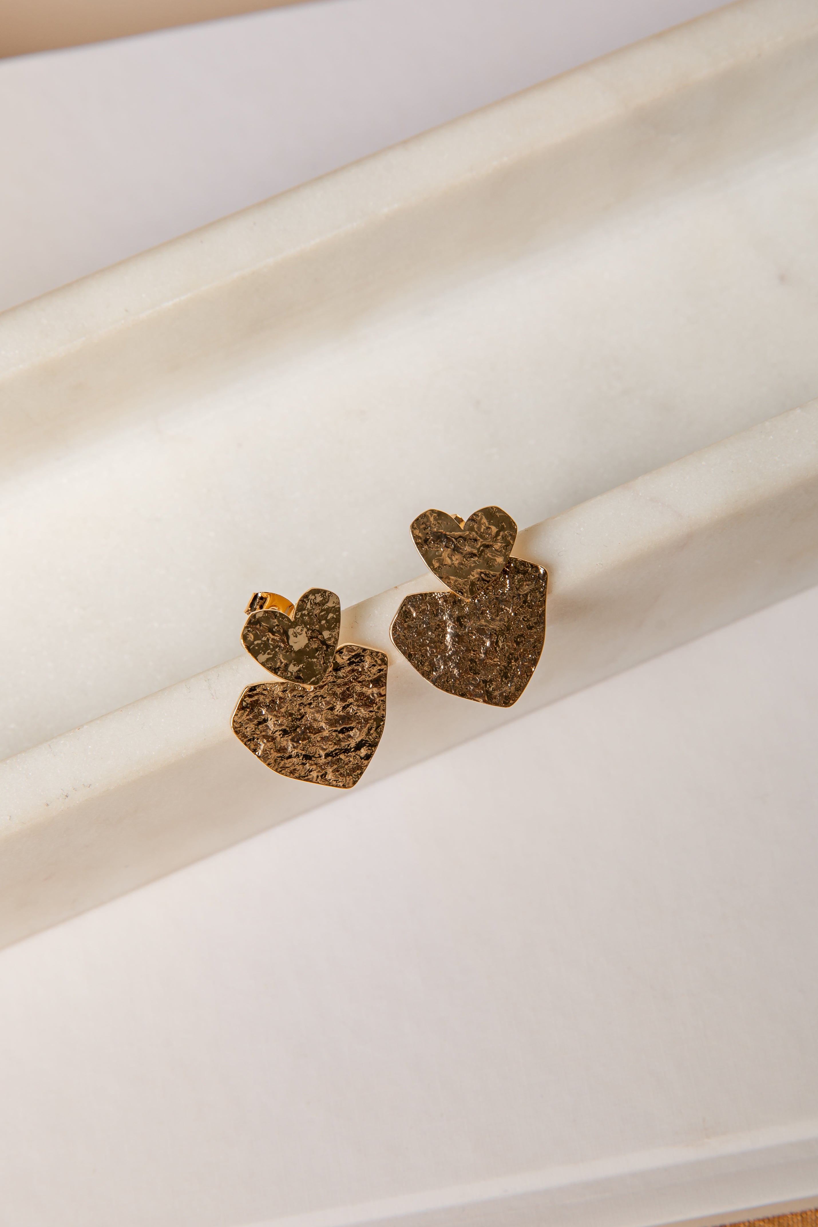 Heart-shaped earrings on a white surface