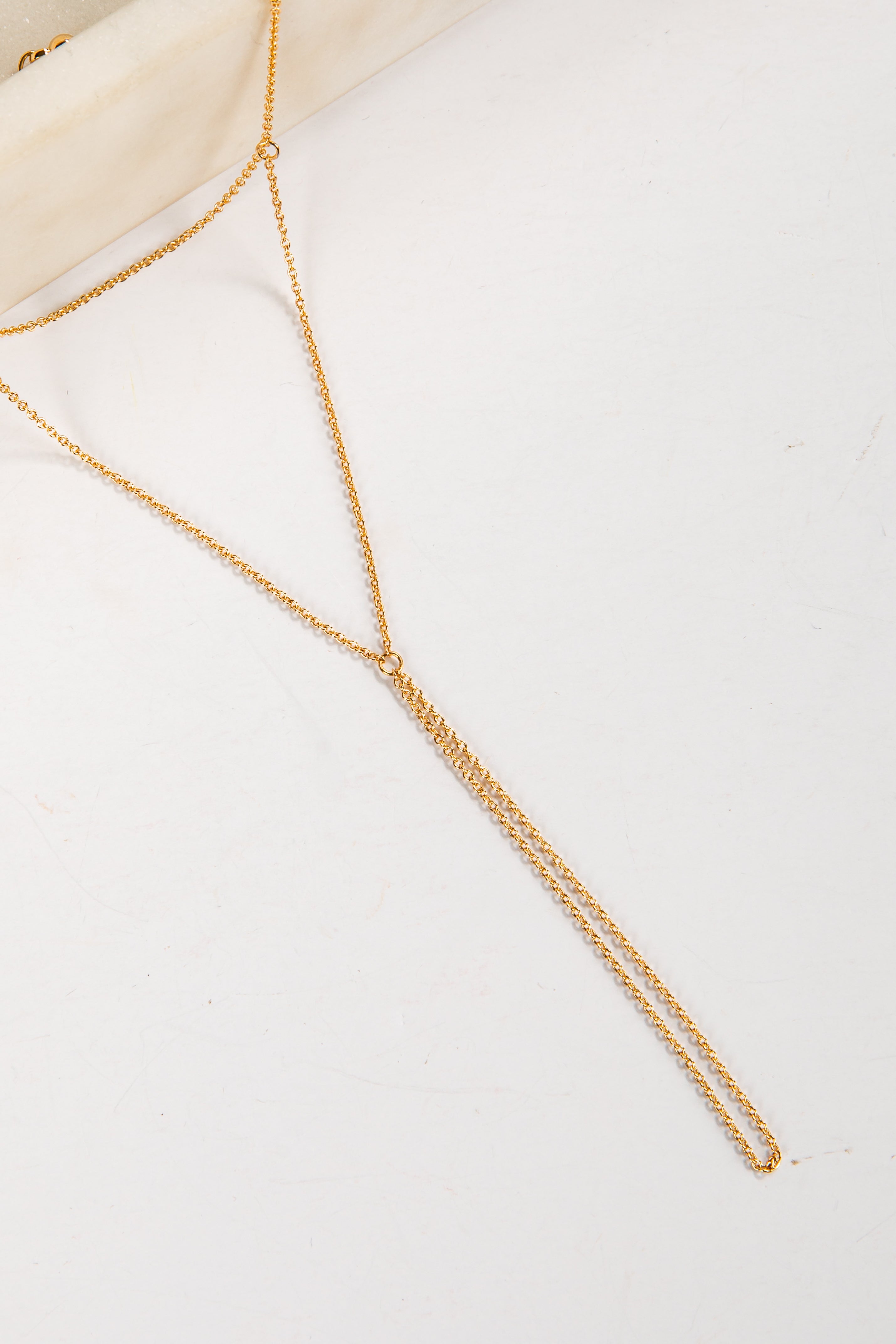 Gold body chain on a white background