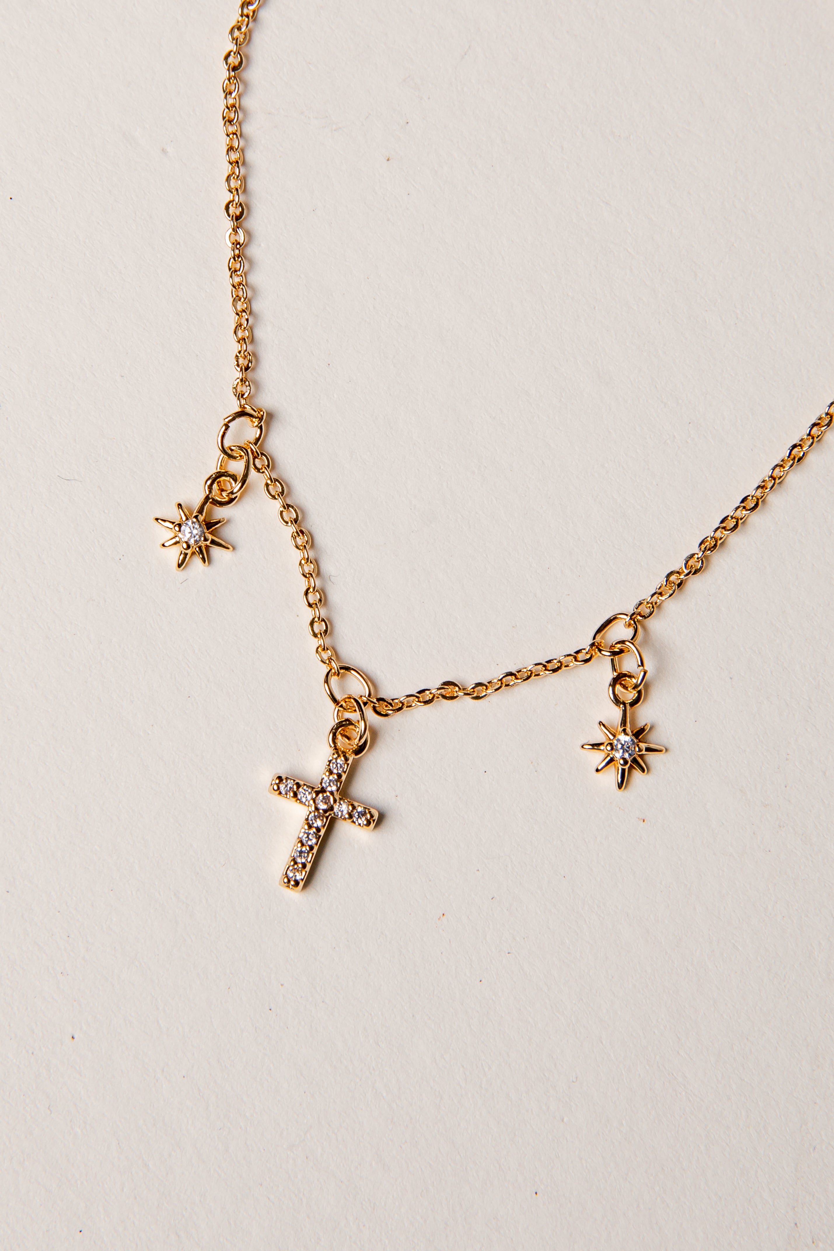 Gold Necklace against plain background