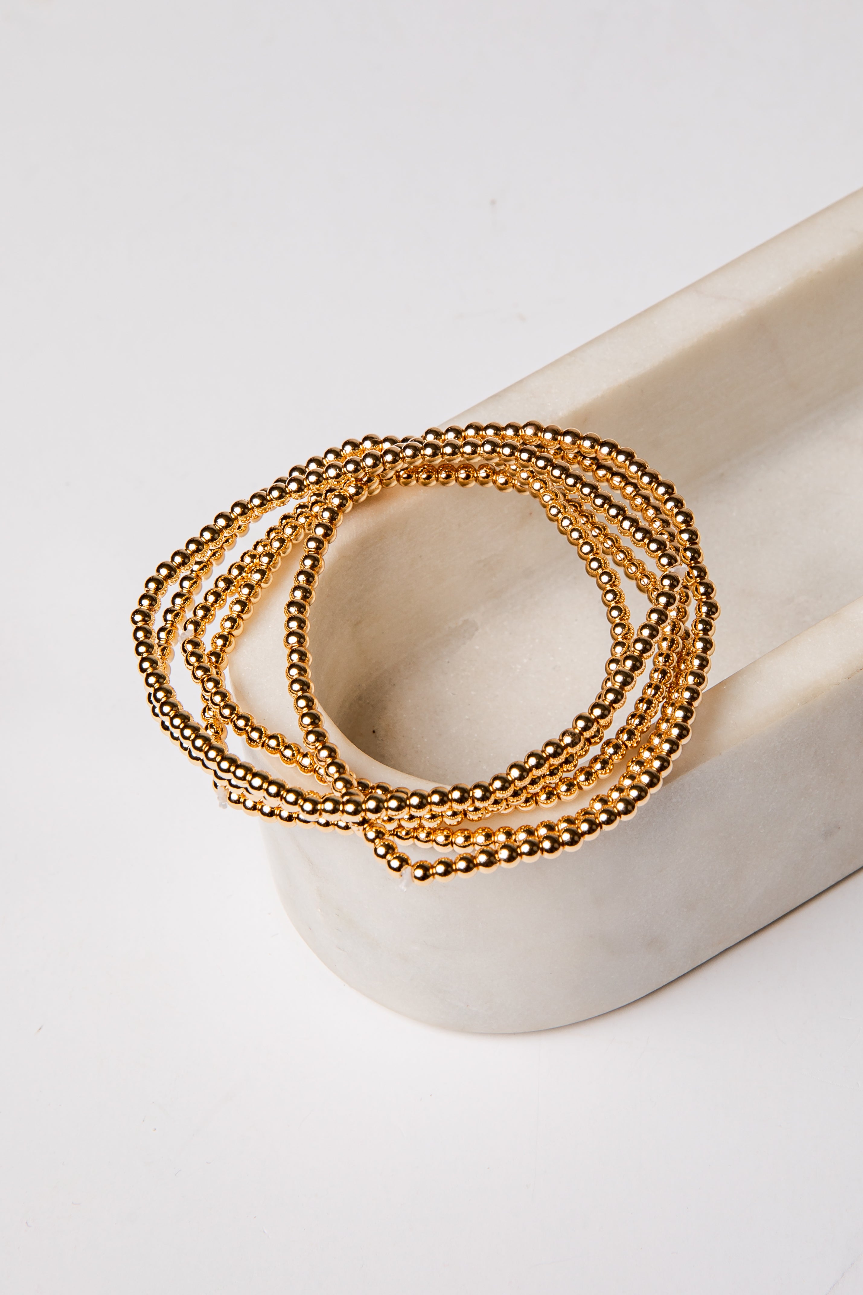 set of 5 gold beaded bracelets