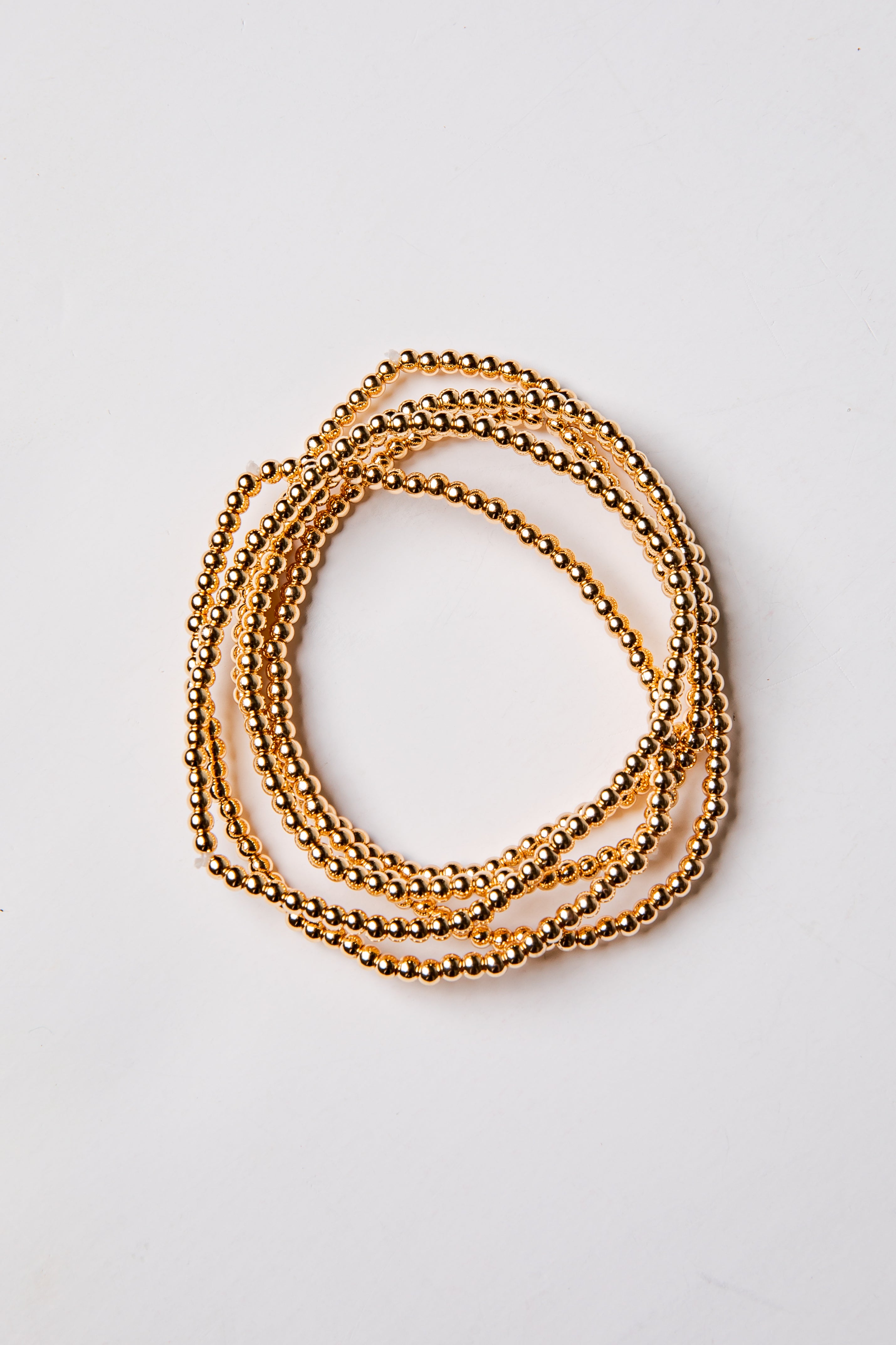 set of 5 gold beaded bracelets