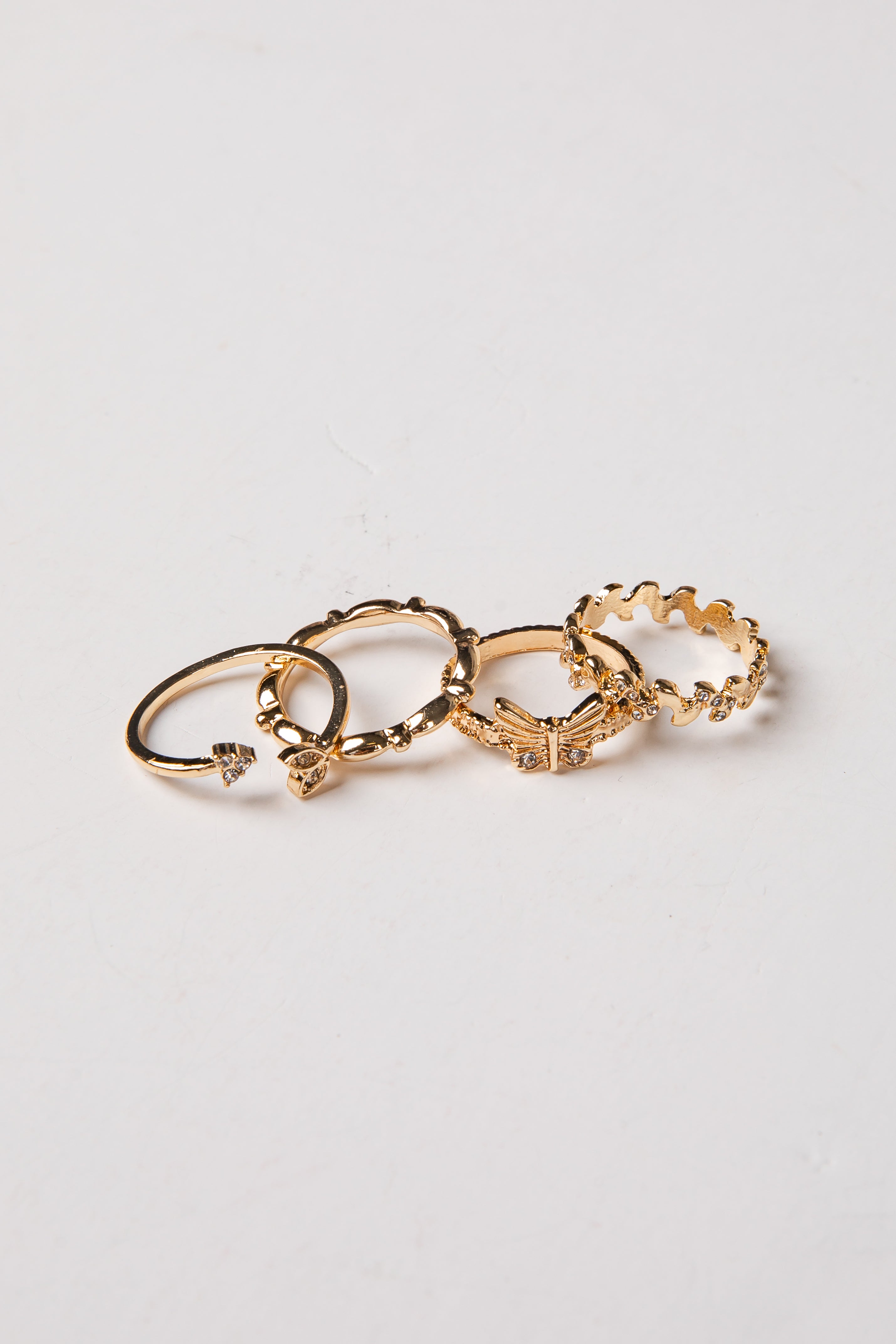 Set of gold hoop earrings on a light gray background