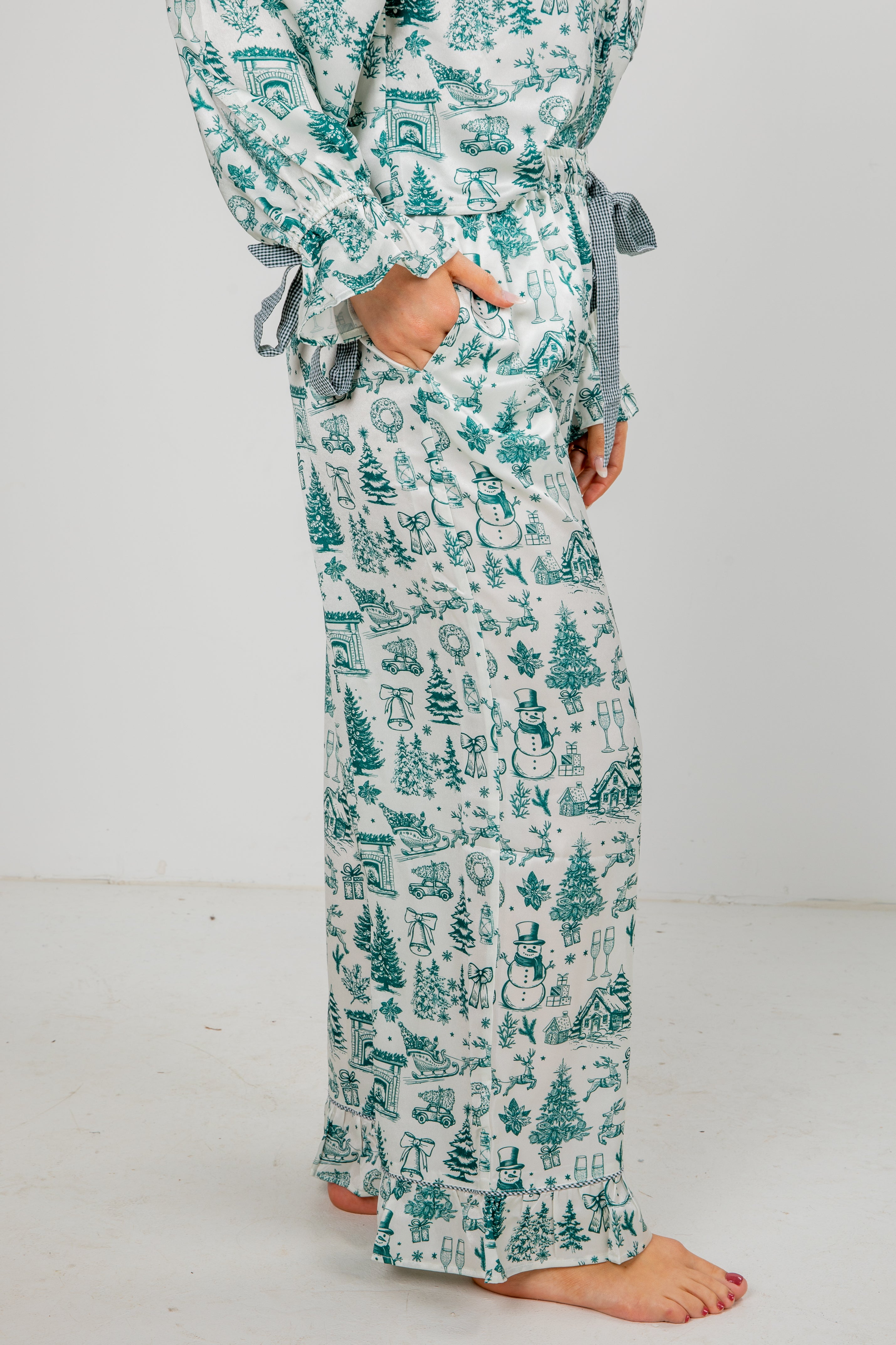 Person wearing a long, patterned robe with Christmas-themed designs on a white background