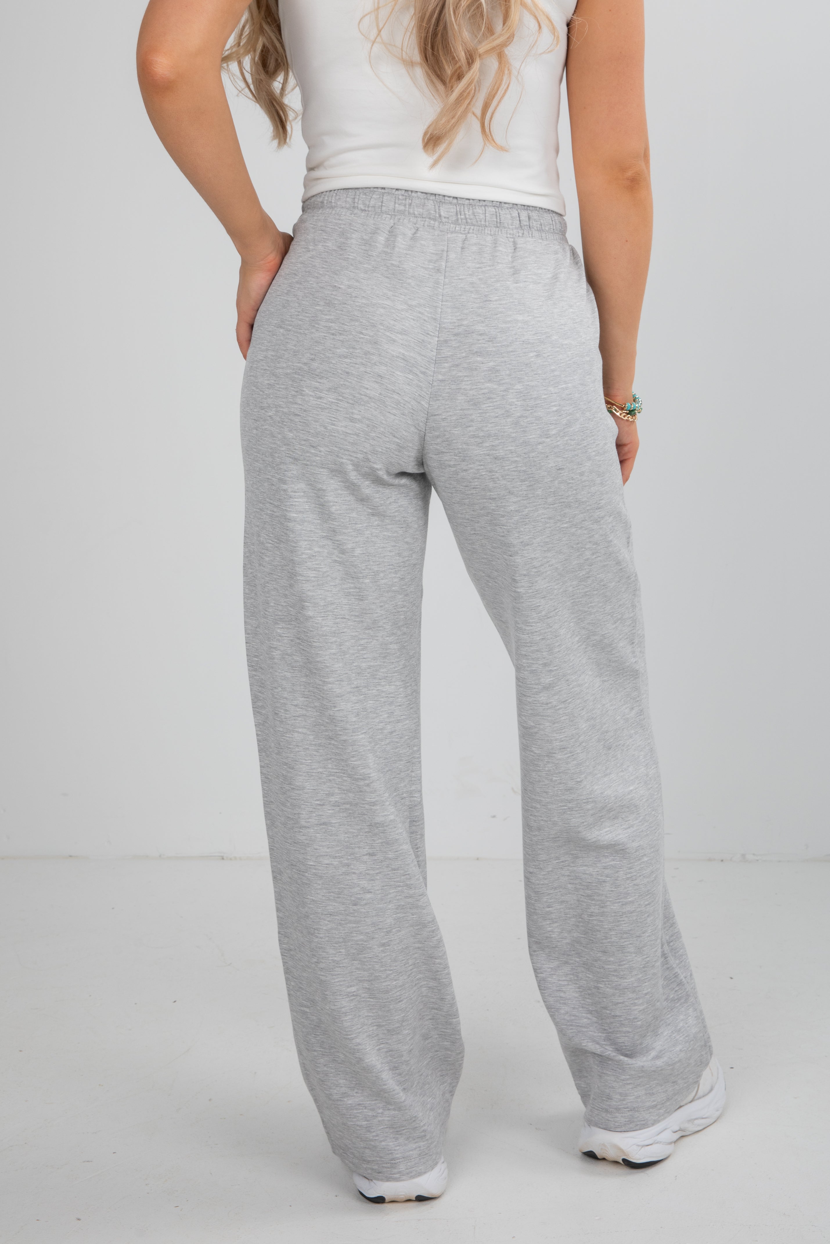 Person wearing gray sweatpants on a white background