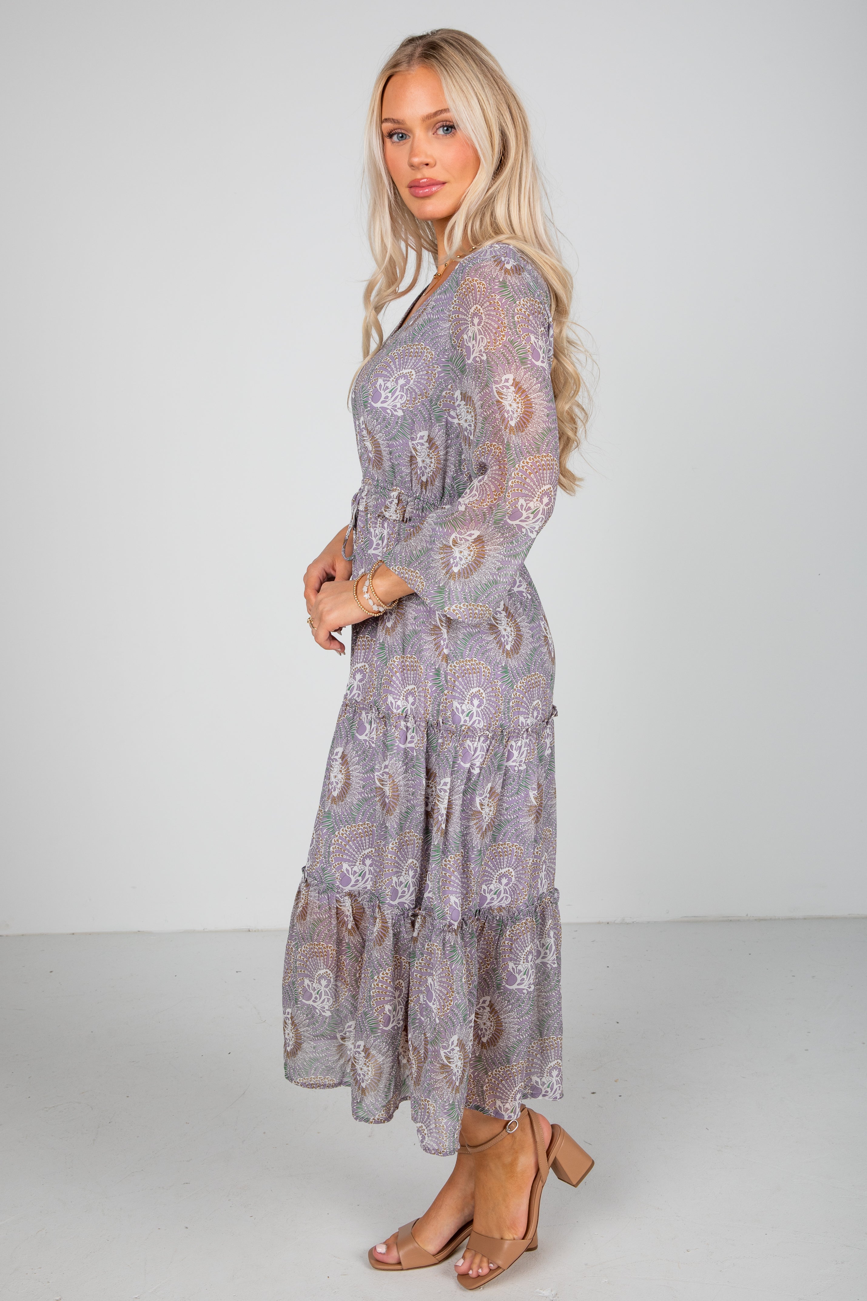 Woman wearing a floral dress with a plain background