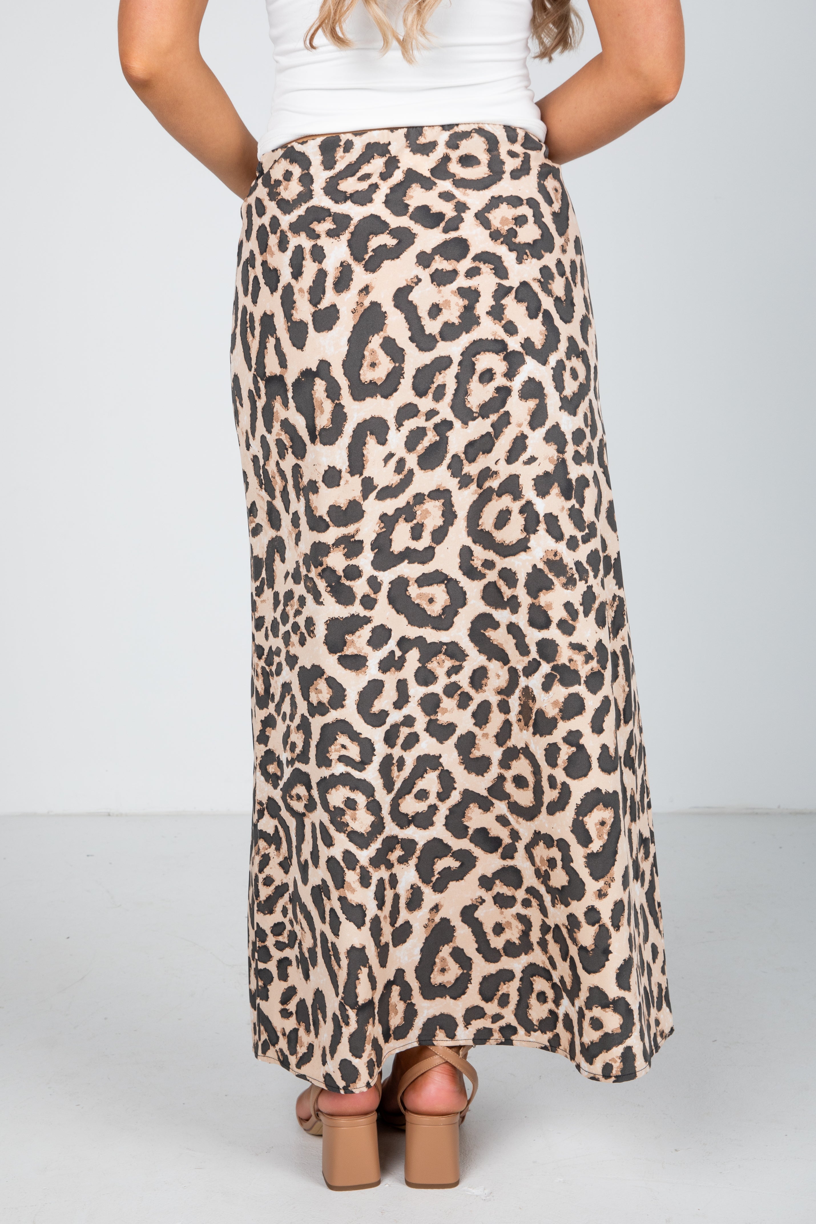 Leopard print skirt worn by a person on a plain background