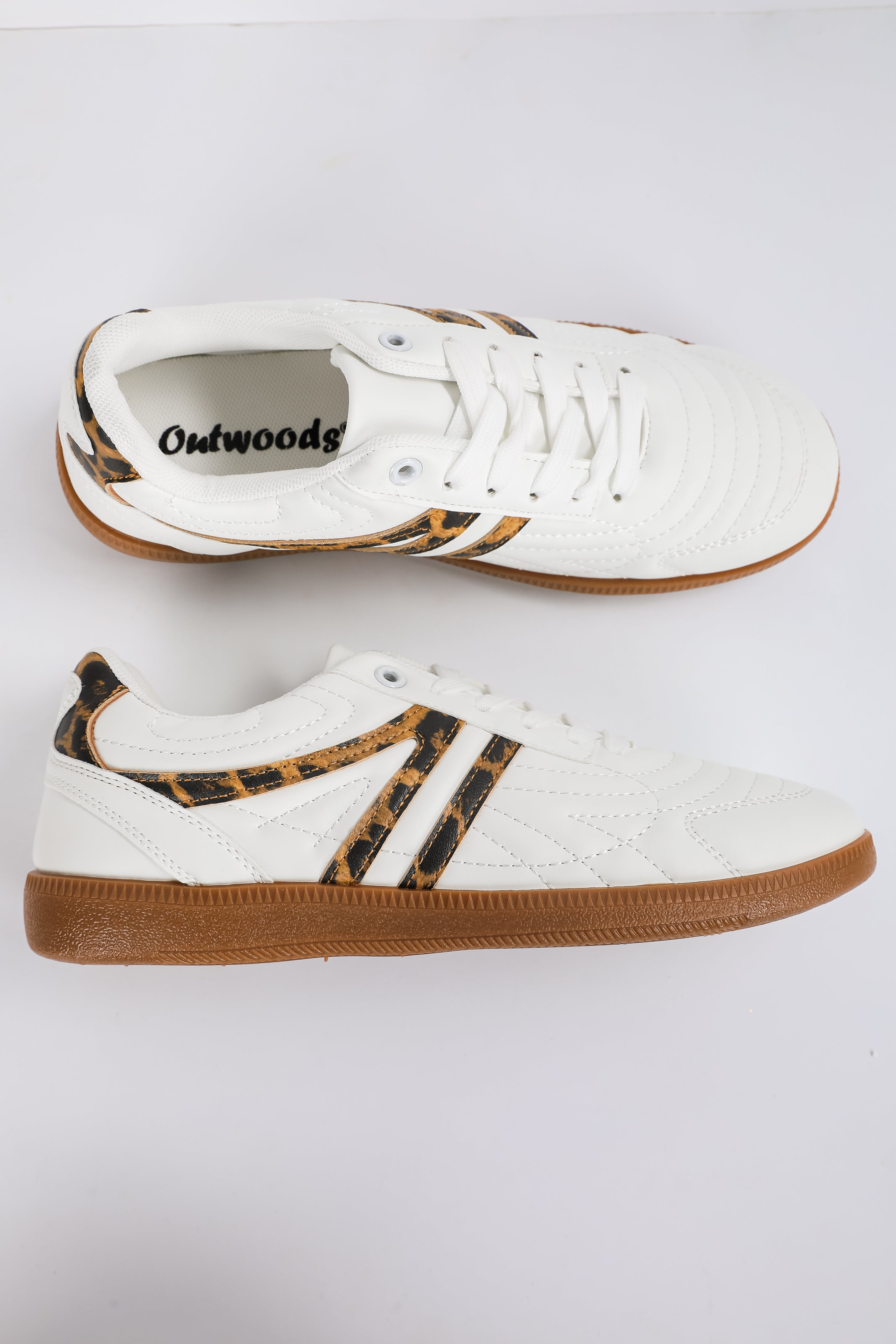 White sneakers with brown accents on a white background