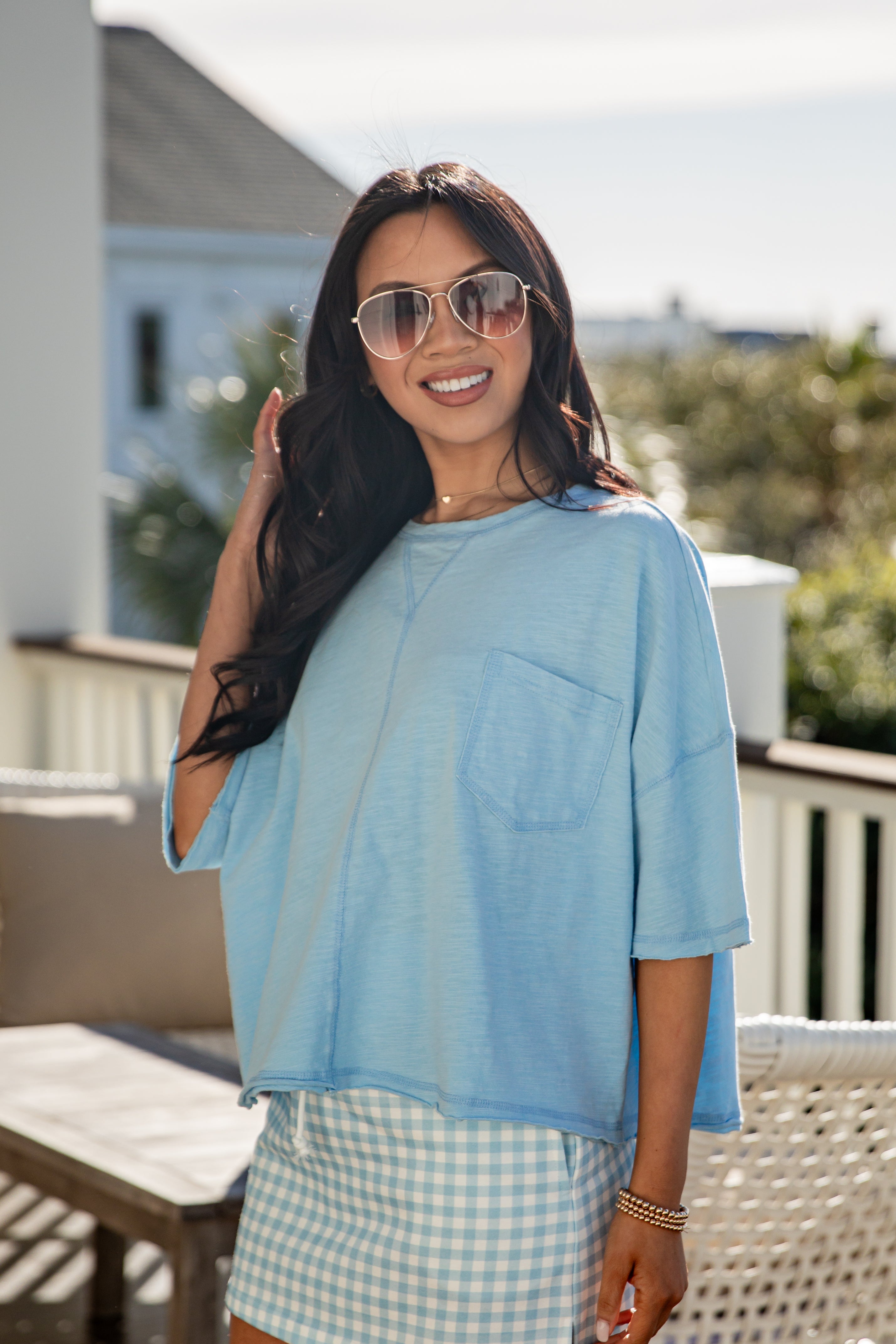 woman wearing a blue casual basic top with front pocket