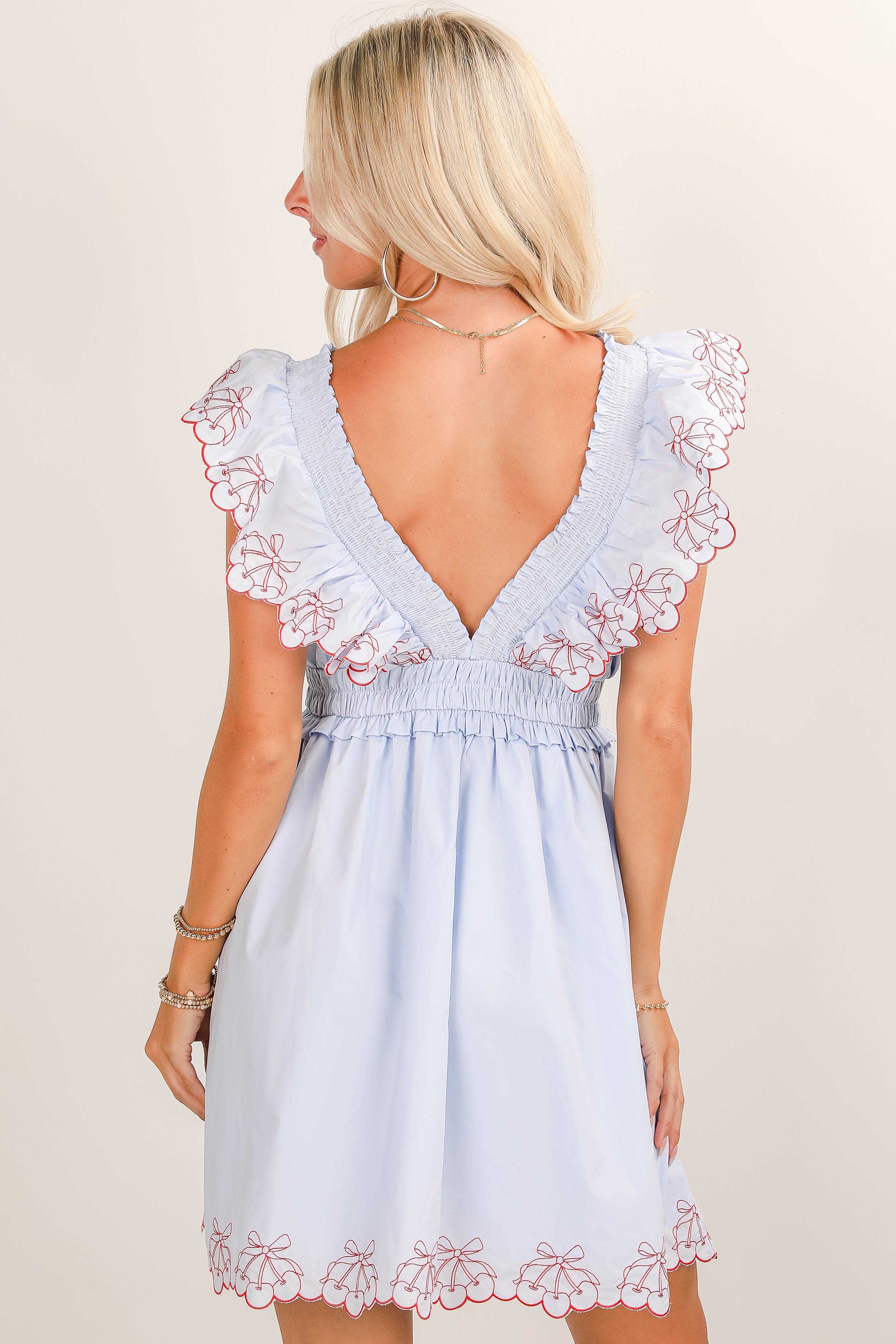 Light blue dress with floral lace details on a plain background