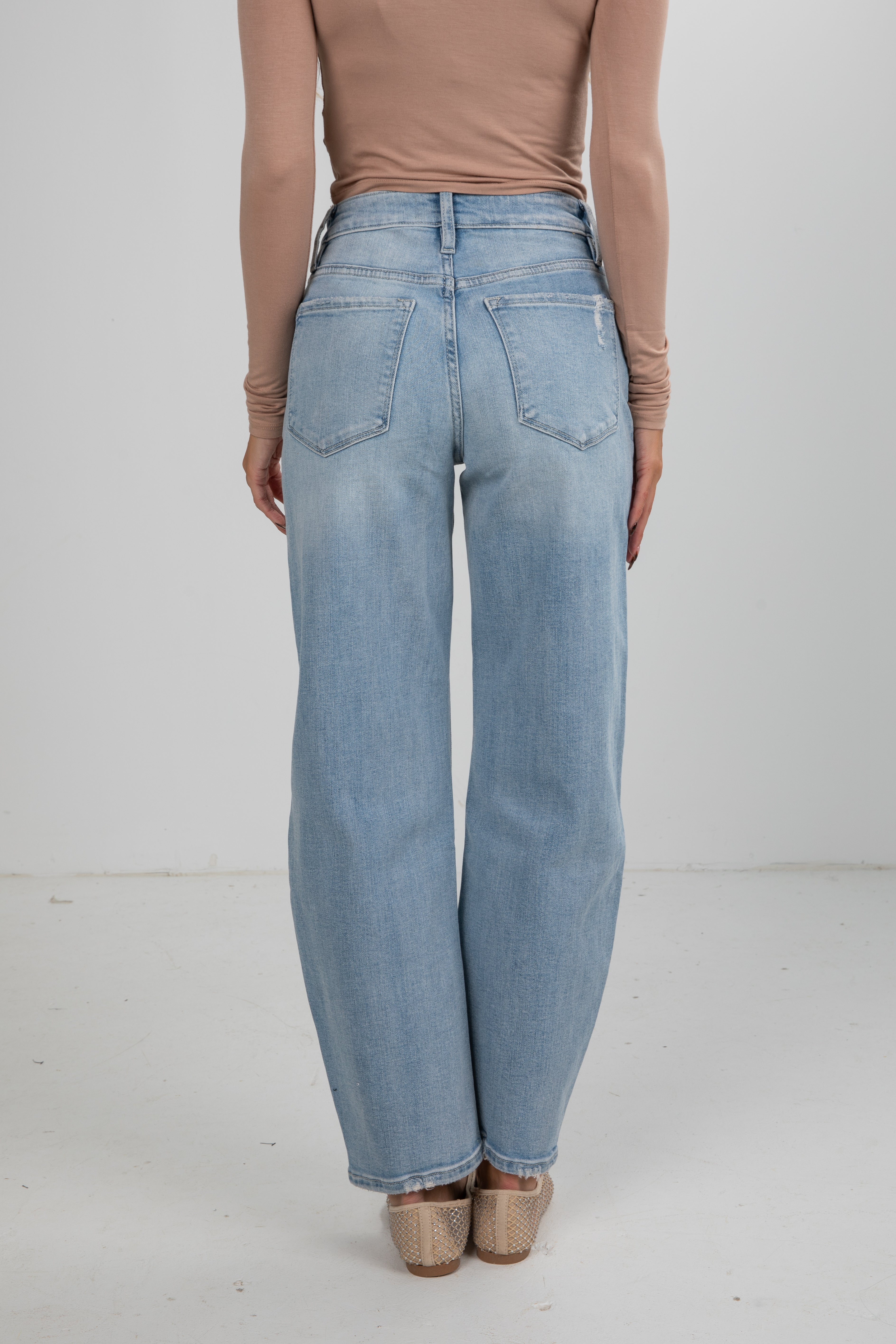 Light blue jeans worn by a person on a white background