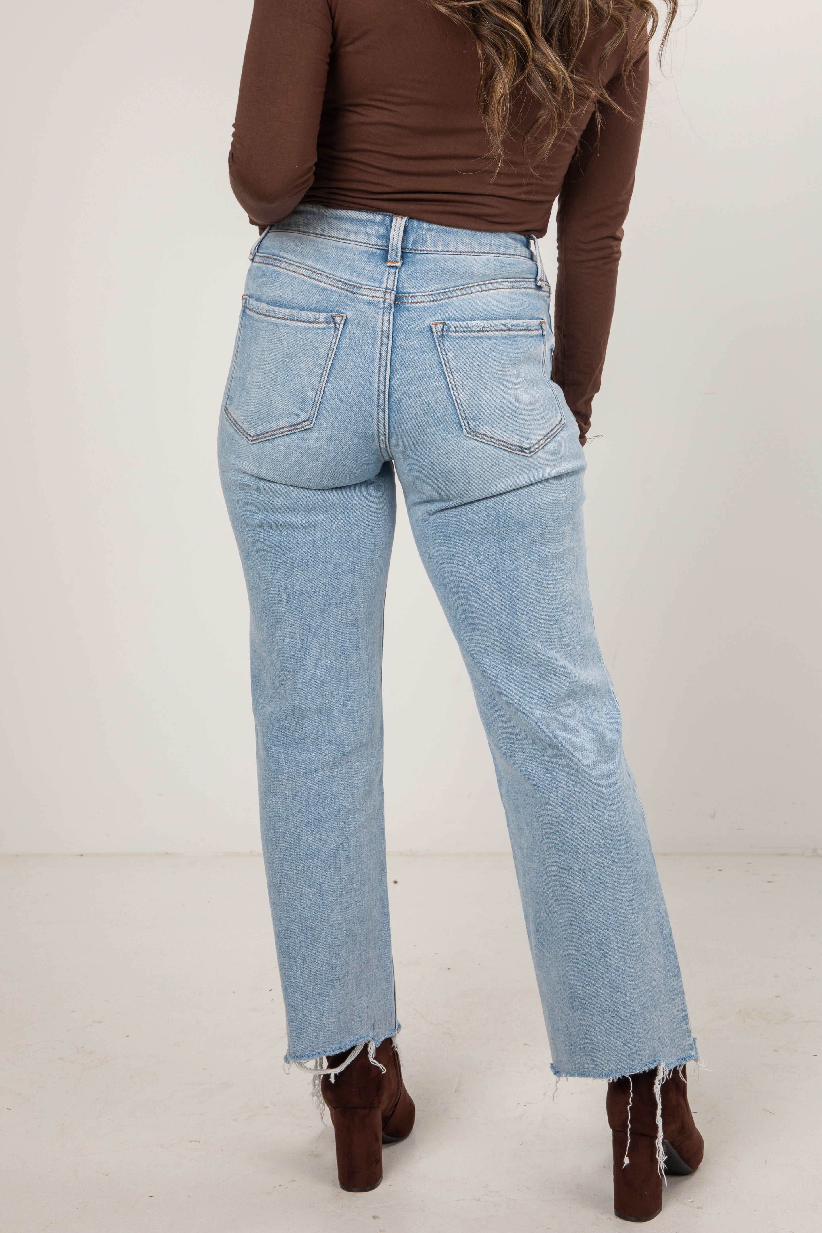 Light blue jeans worn by a person on a white background