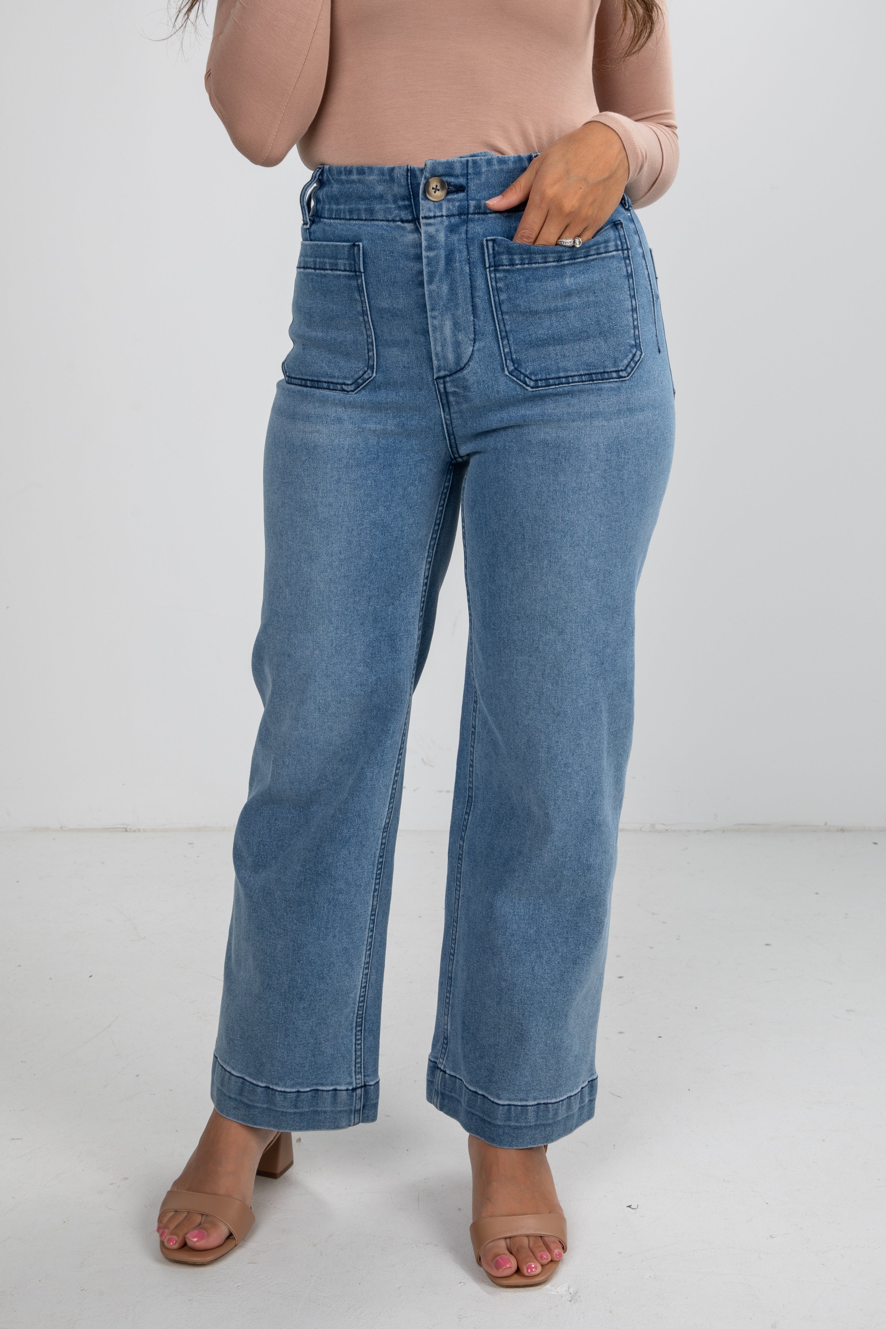 Person wearing blue jeans on a white background