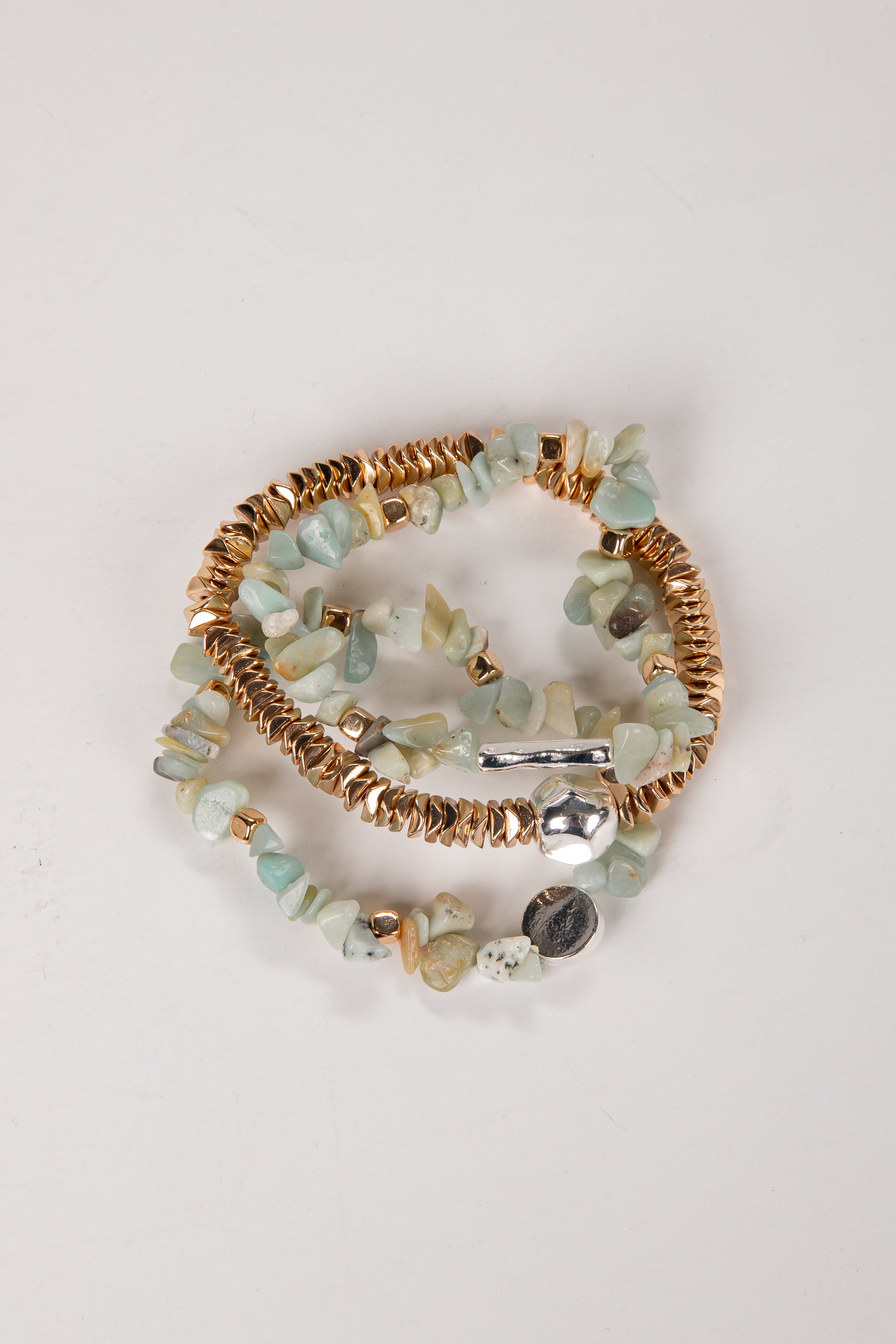 Set of beaded bracelets with gold accents on a light background