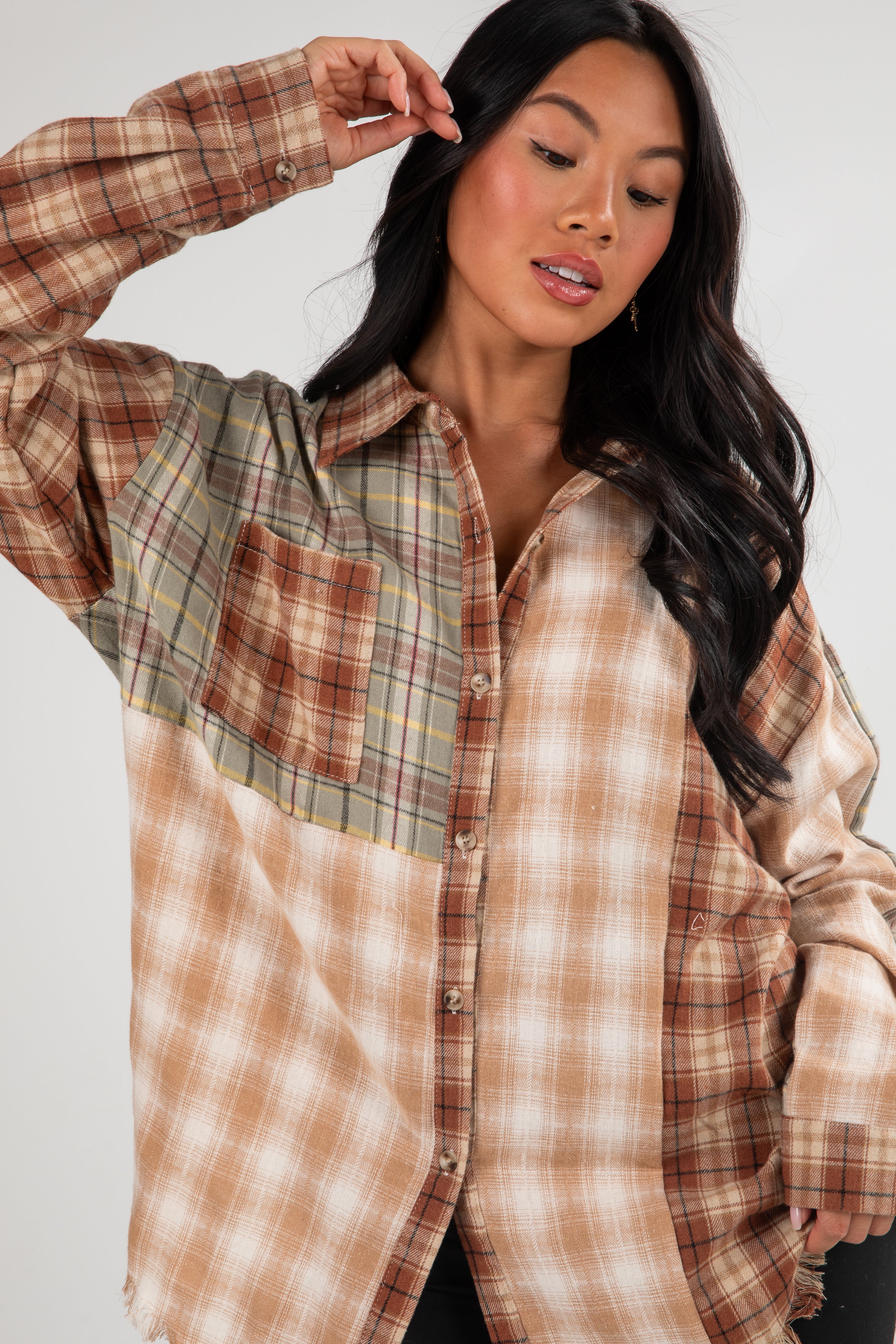 Woman wearing a plaid shirt with a neutral background