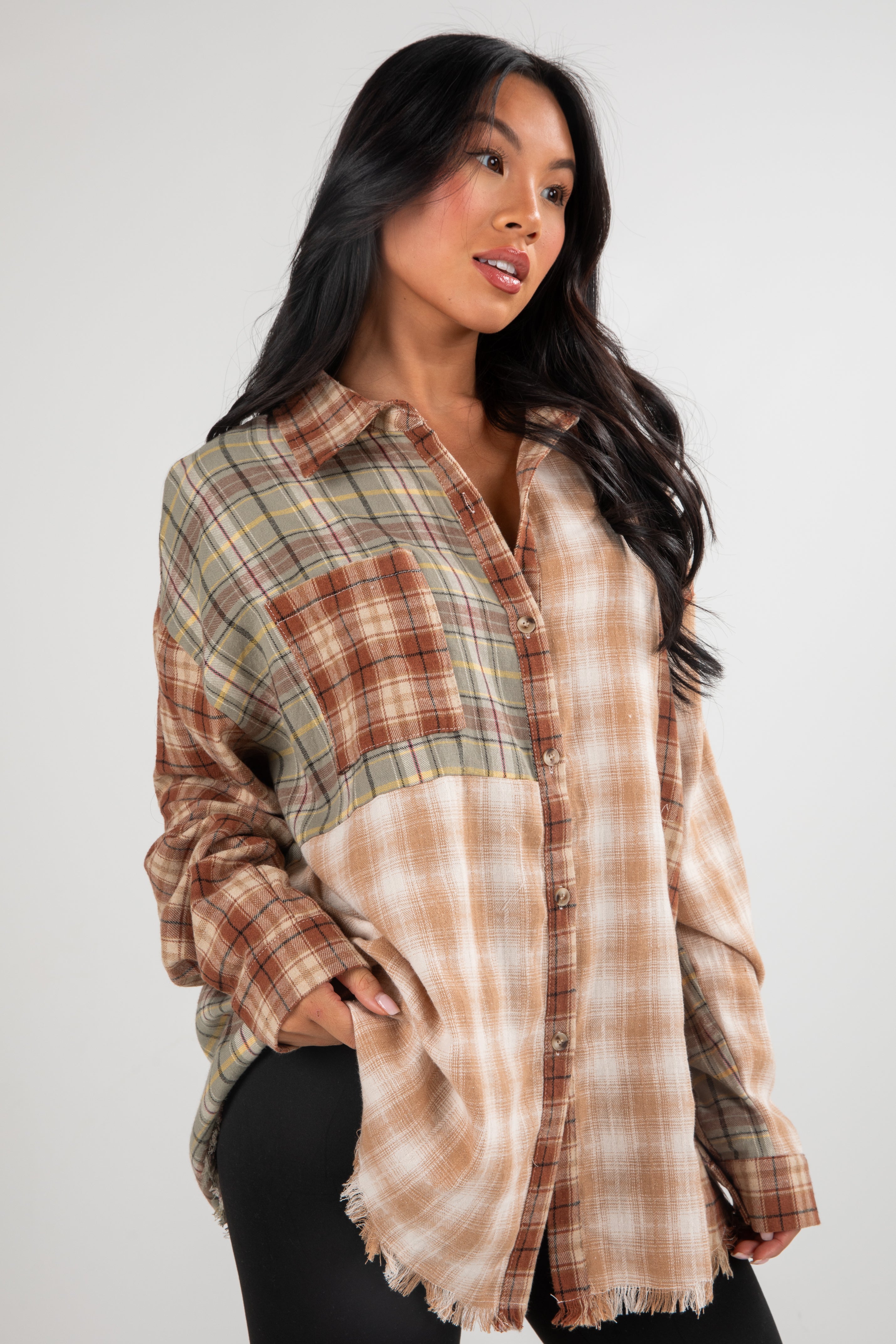 Woman wearing a plaid shirt with a neutral color palette on a white background