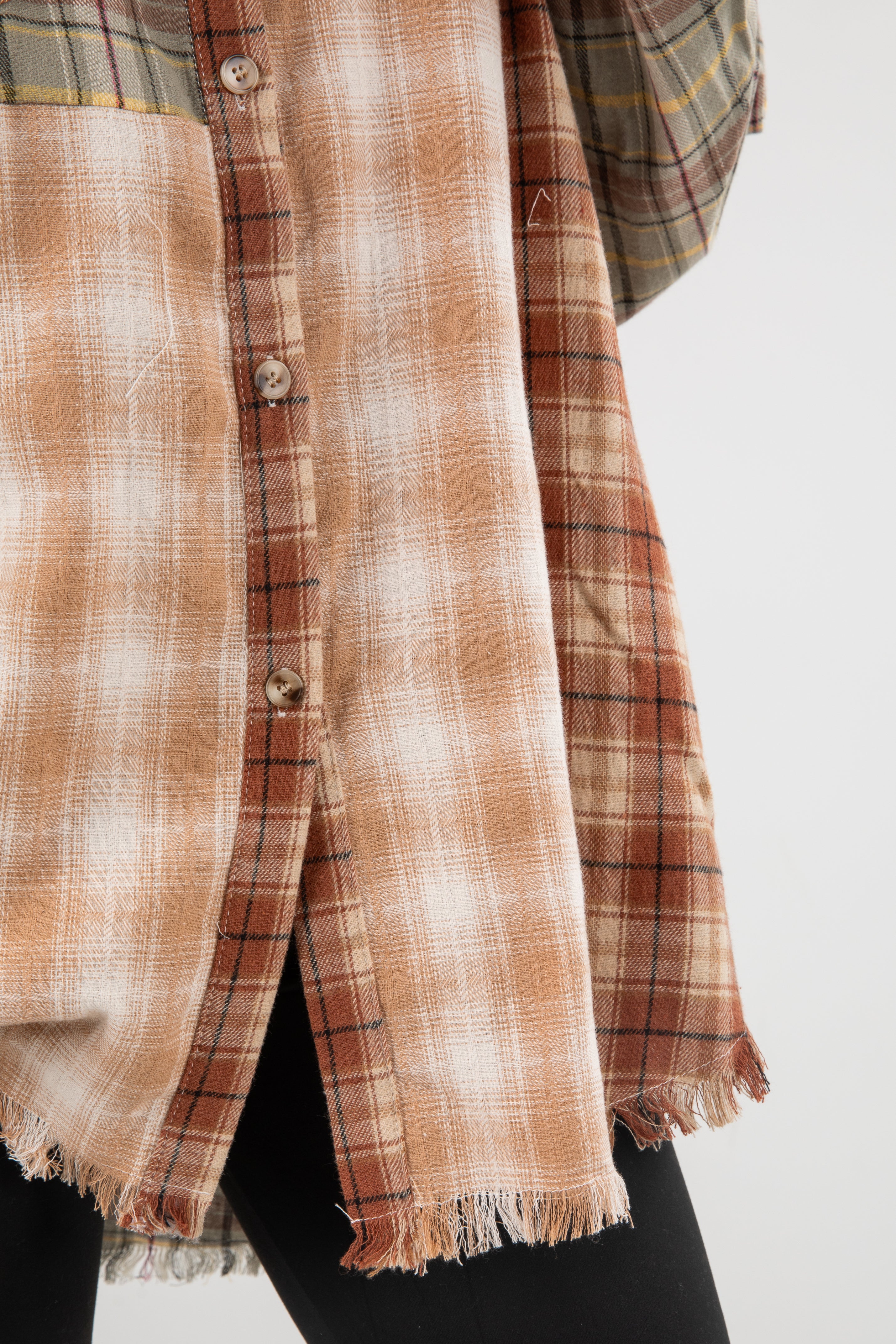 Plaid shirt with frayed edges on a white background