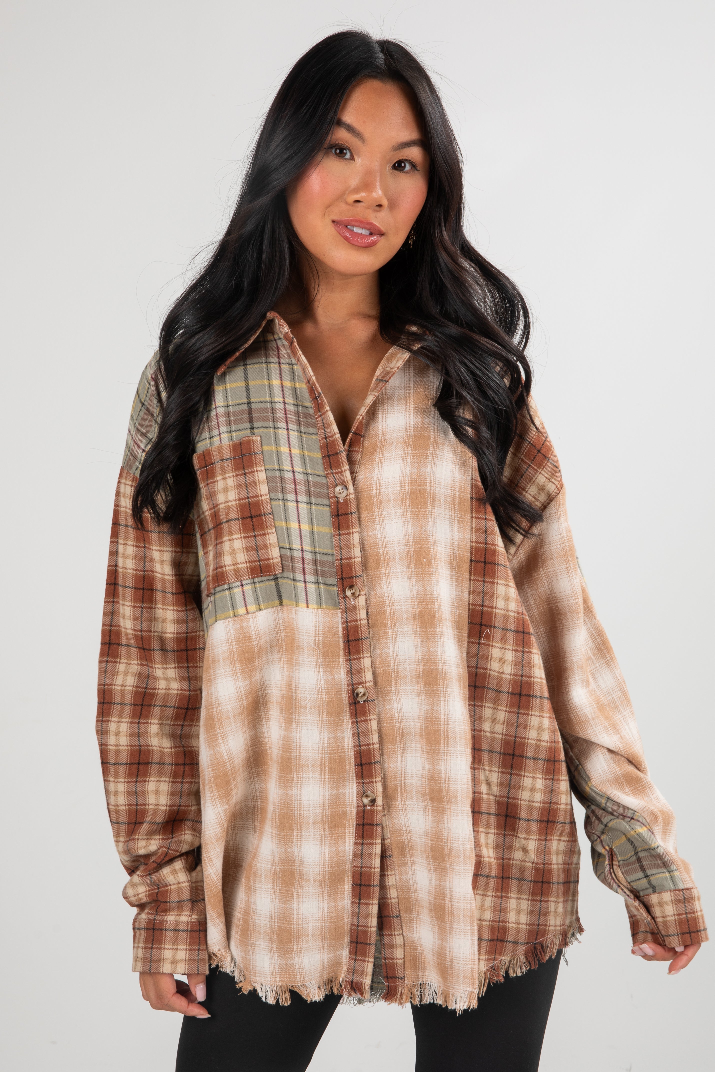 Woman wearing a plaid shirt with a white background