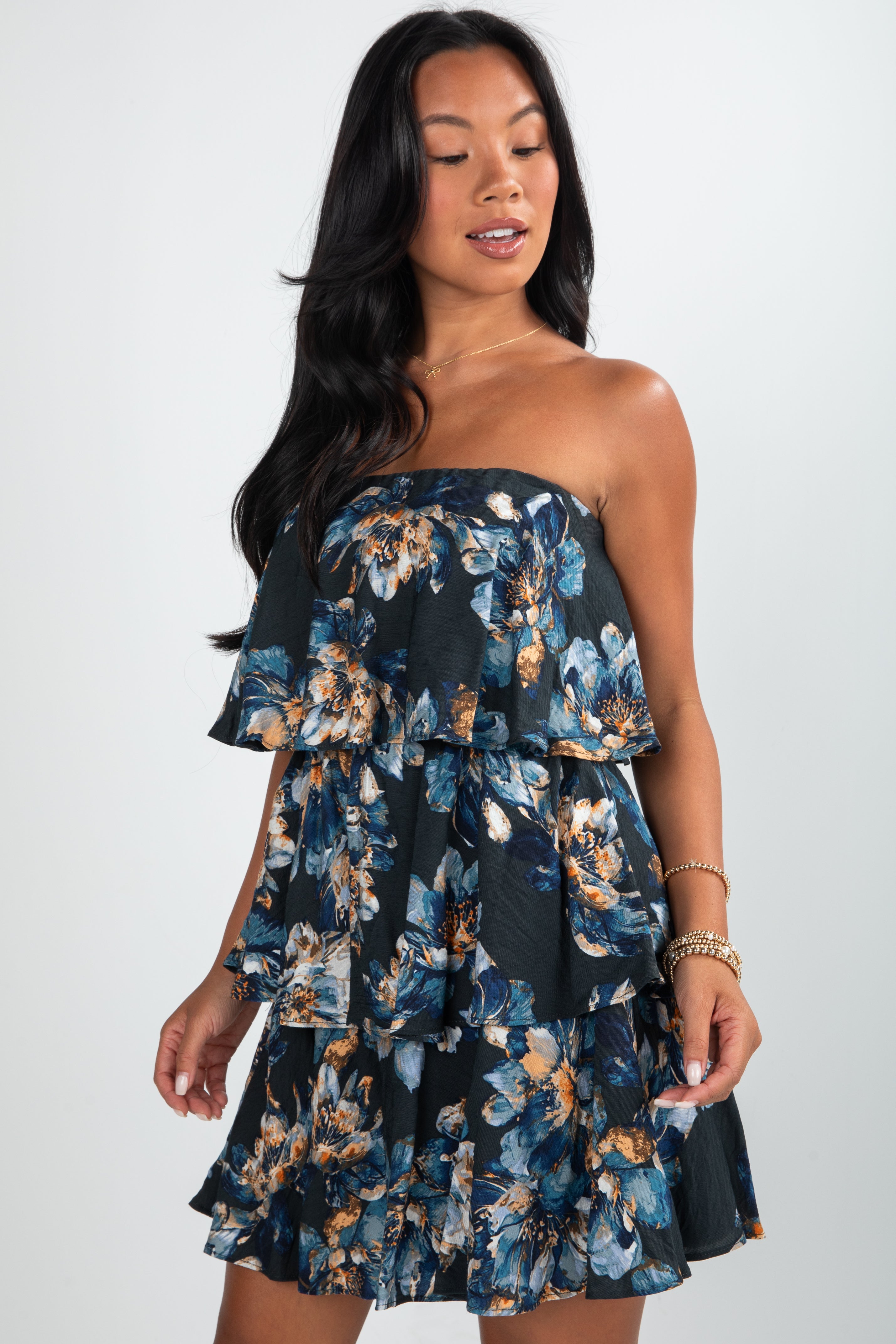 Woman wearing a floral off-shoulder dress against a white background