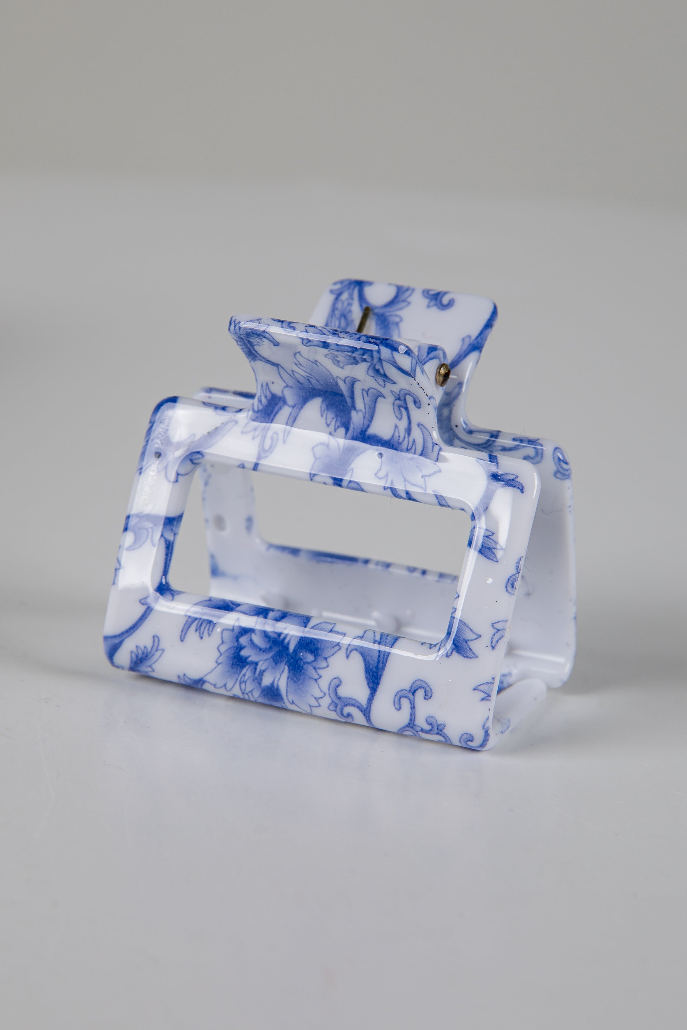 Blue and white patterned handbag on a gray background