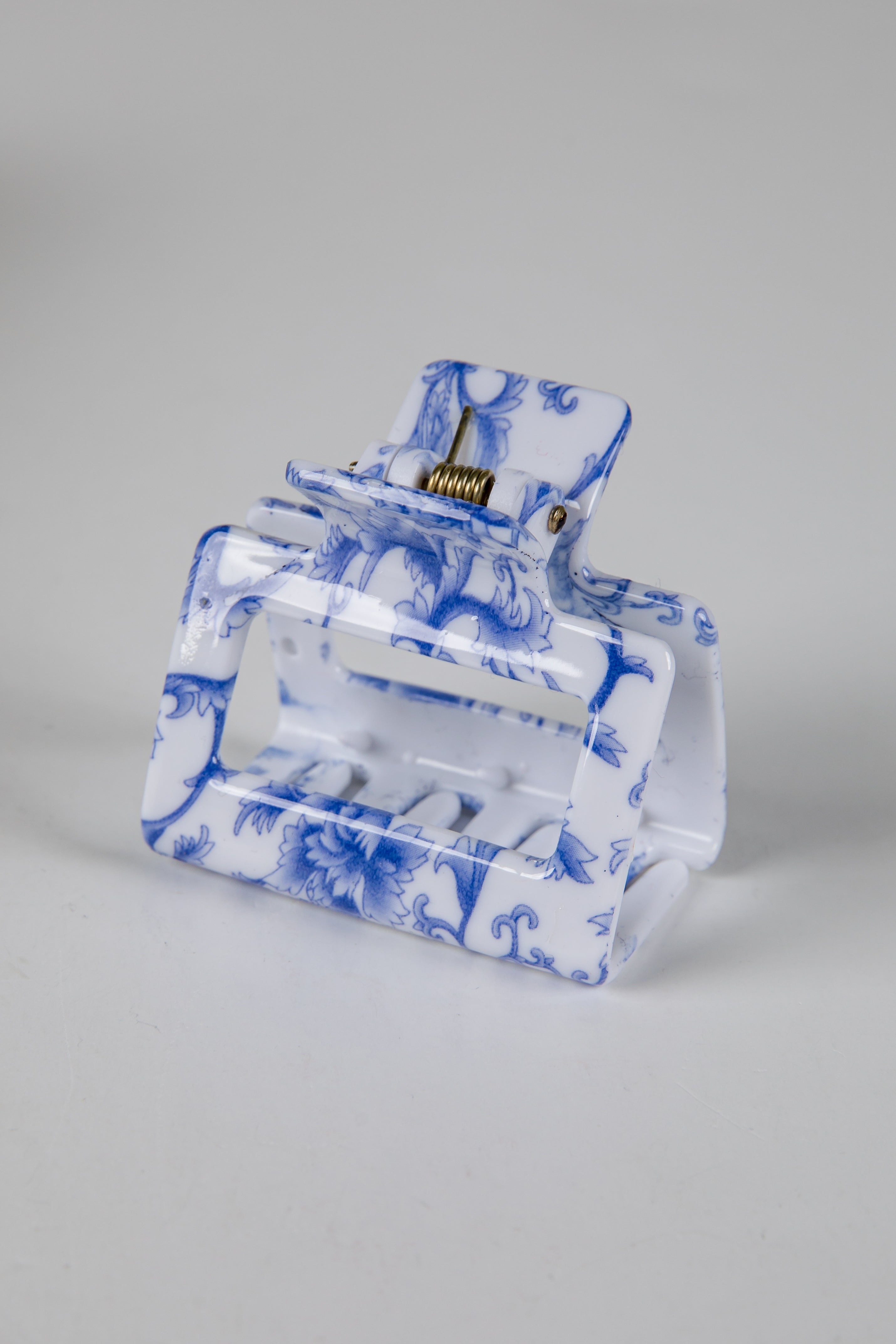 Clear pouch with blue floral pattern on a gray background