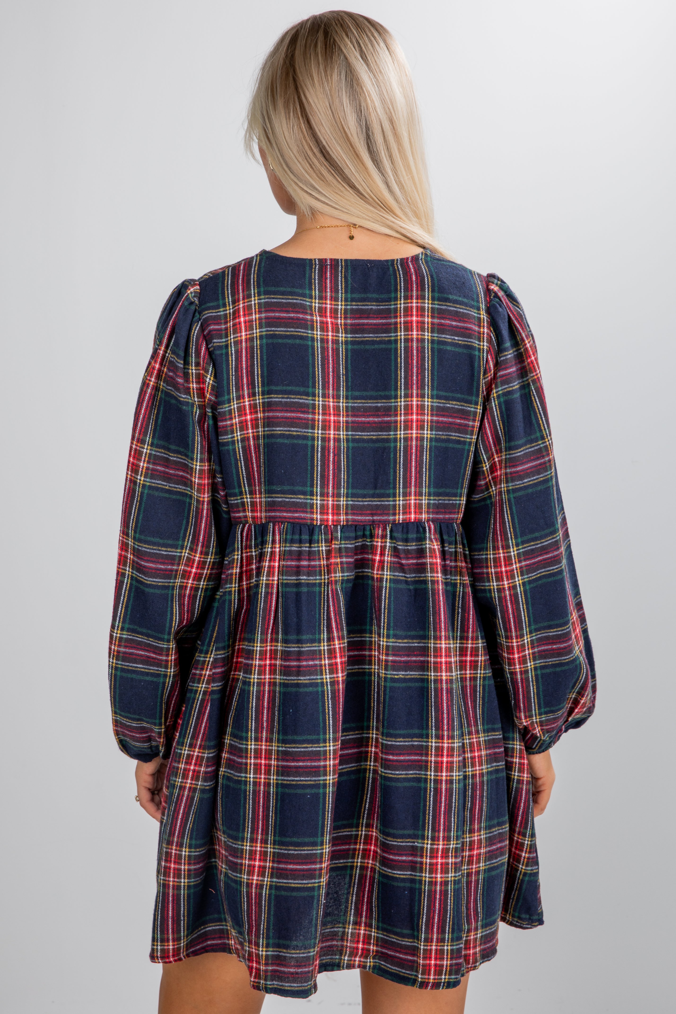 Plaid dress worn by a person on a plain background