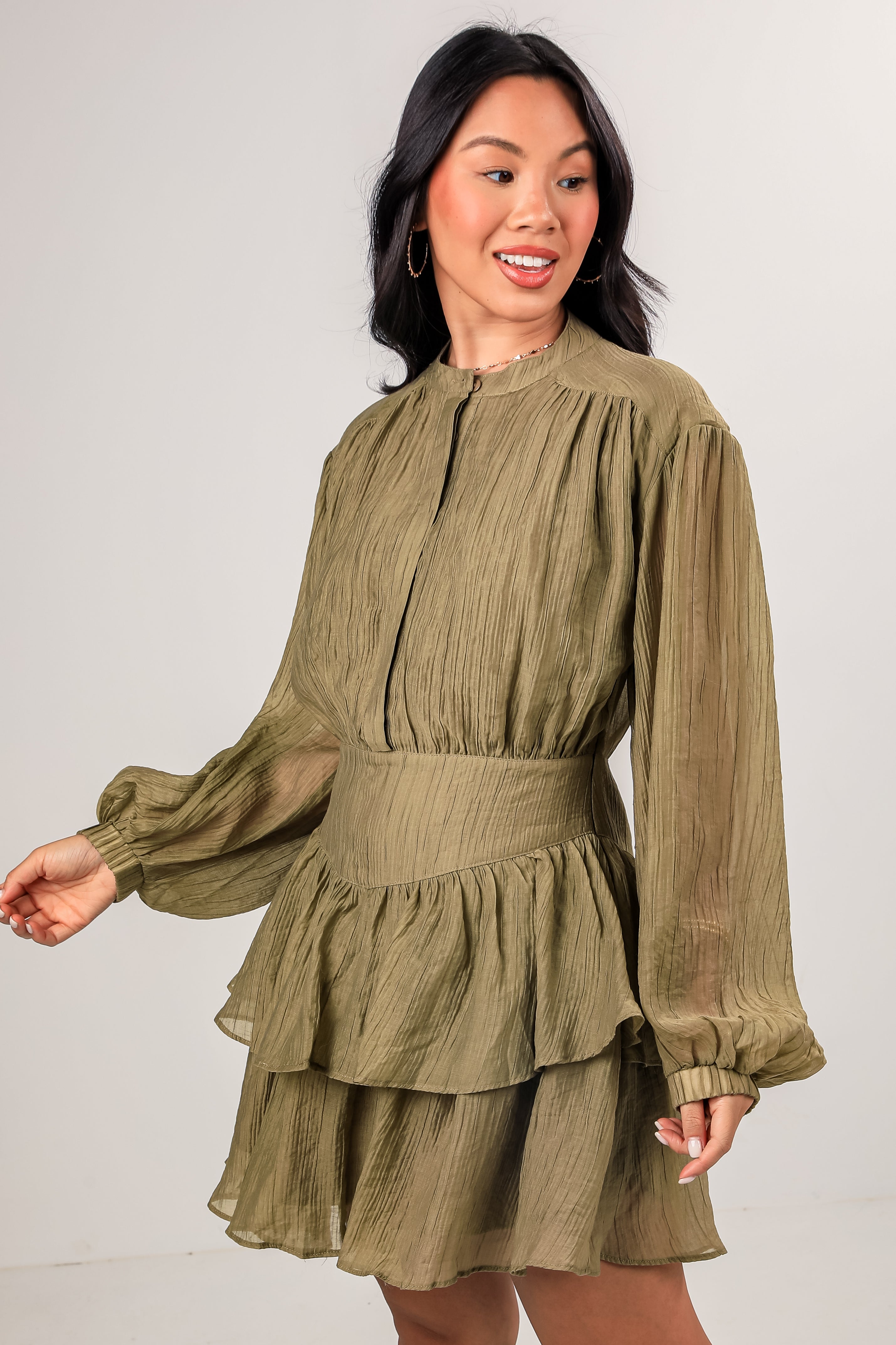 Woman wearing a green dress against a white background