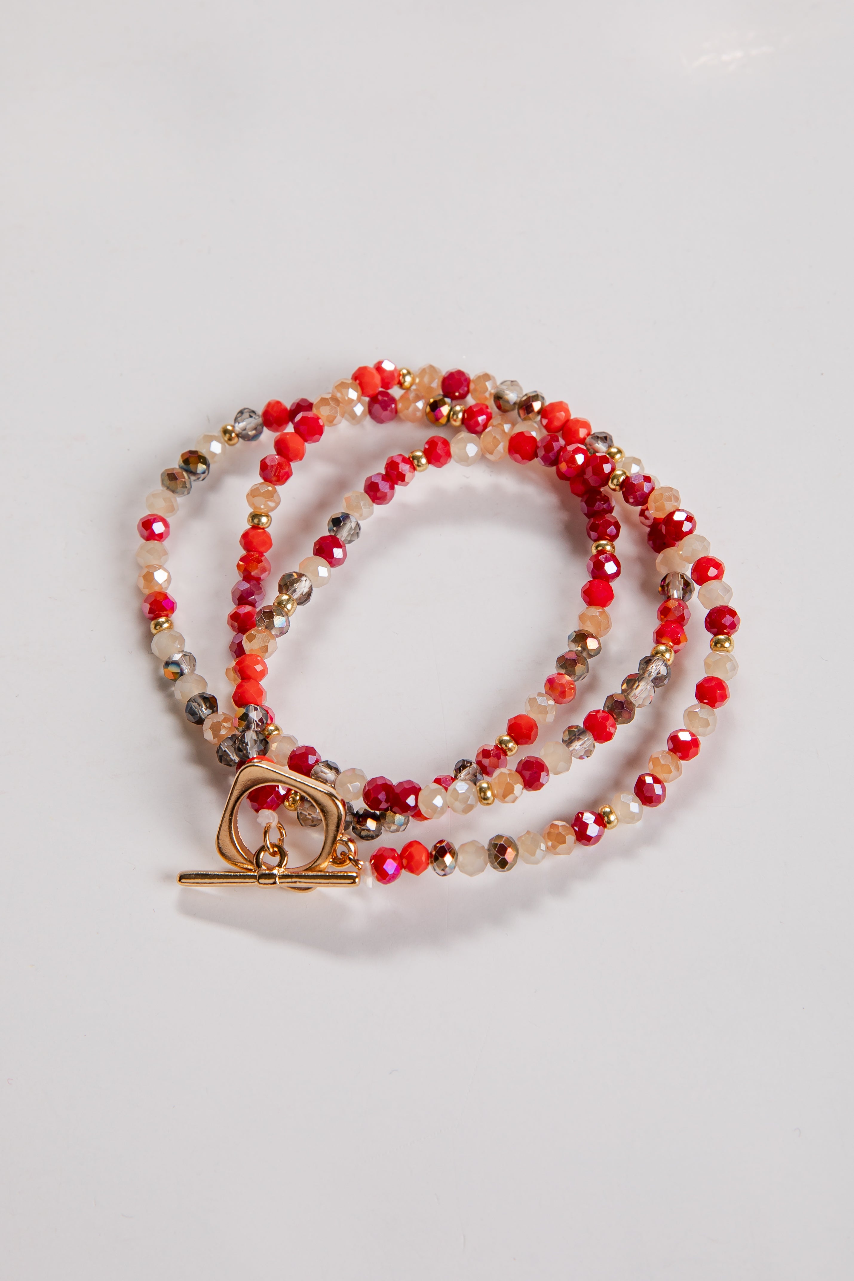 Beaded necklace with a gold clasp on a light gray background