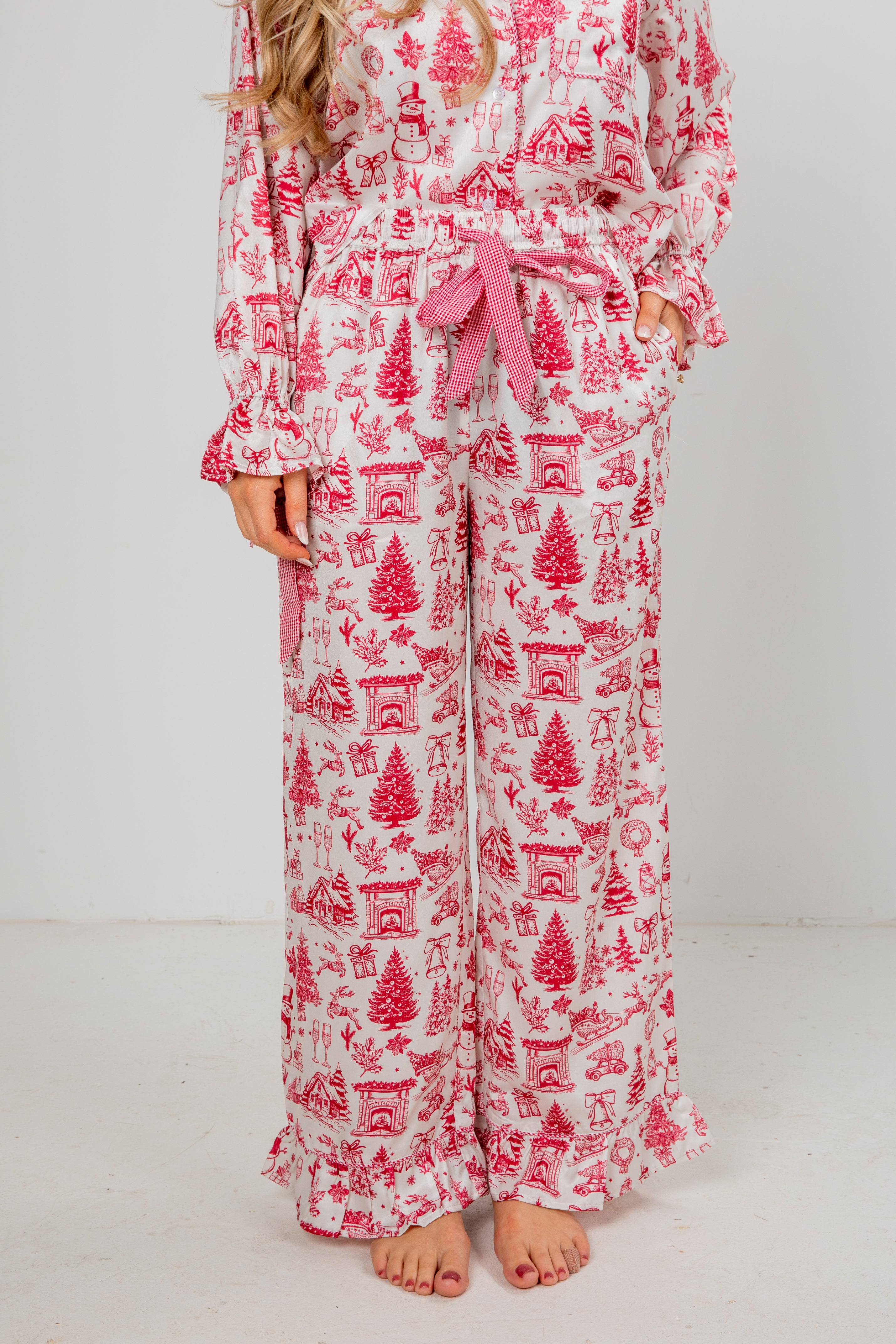 Person wearing a red and white patterned pajama set on a plain background