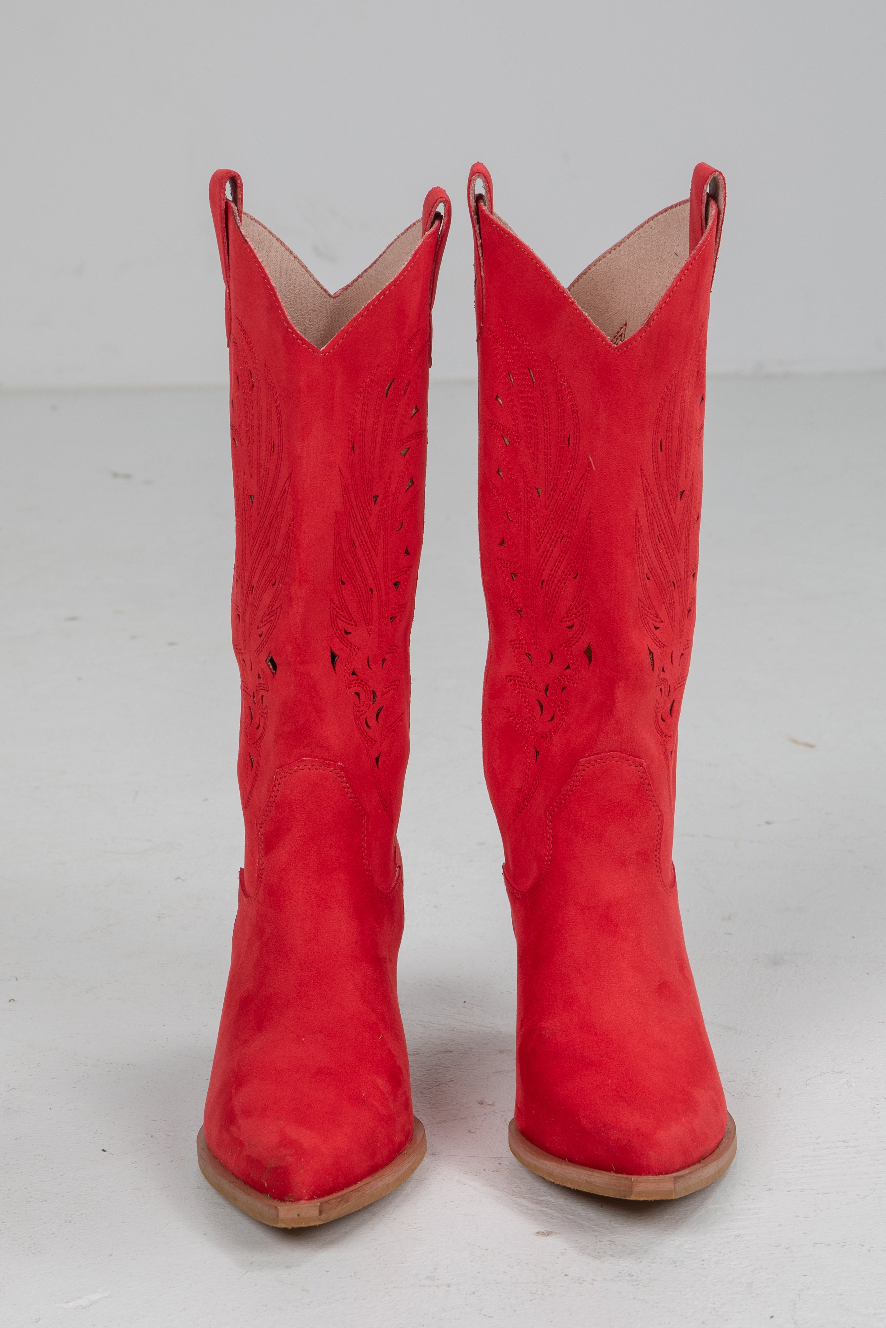 Pair of red cowboy boots on a white background