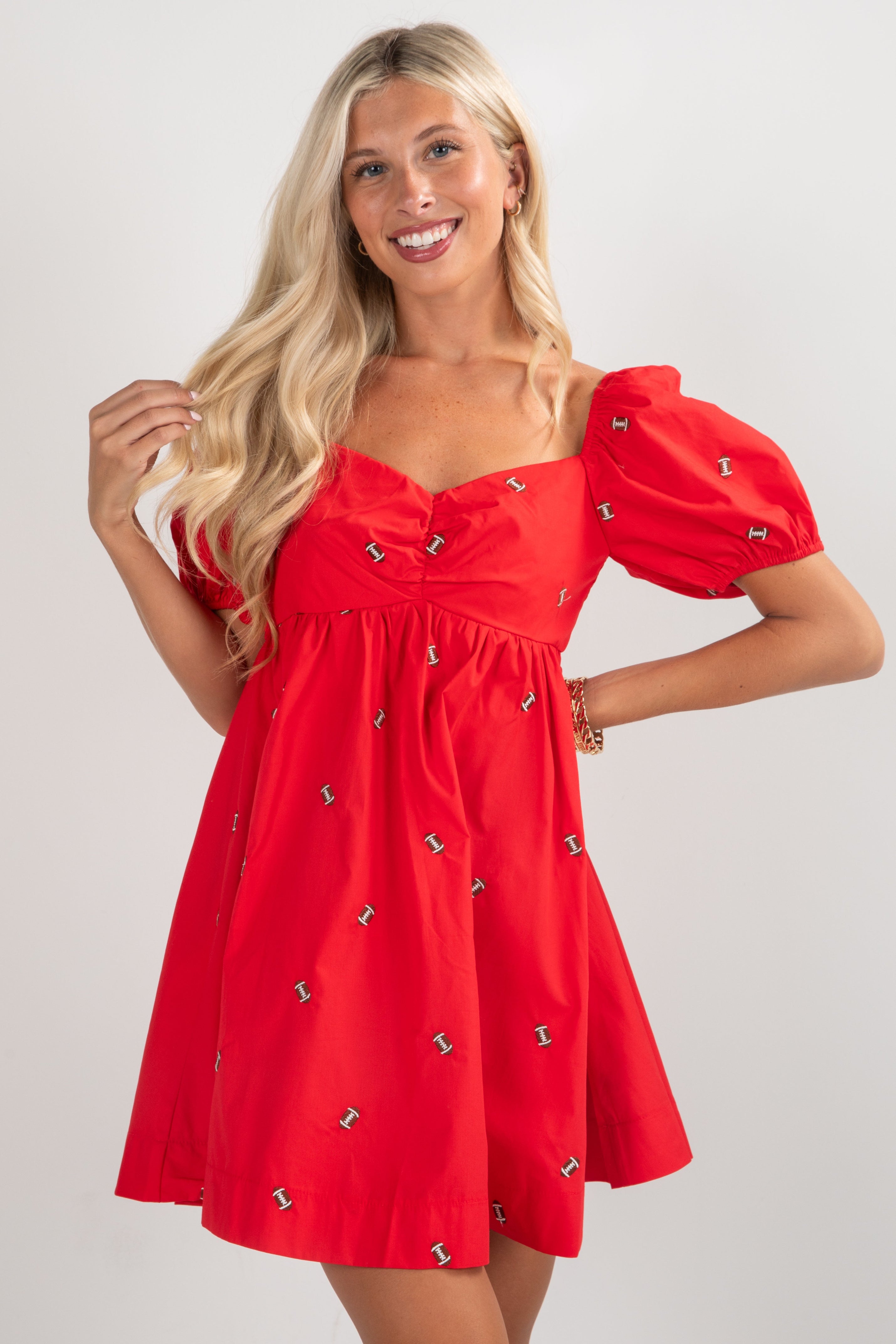 Woman wearing a red dress with puff sleeves on a white background