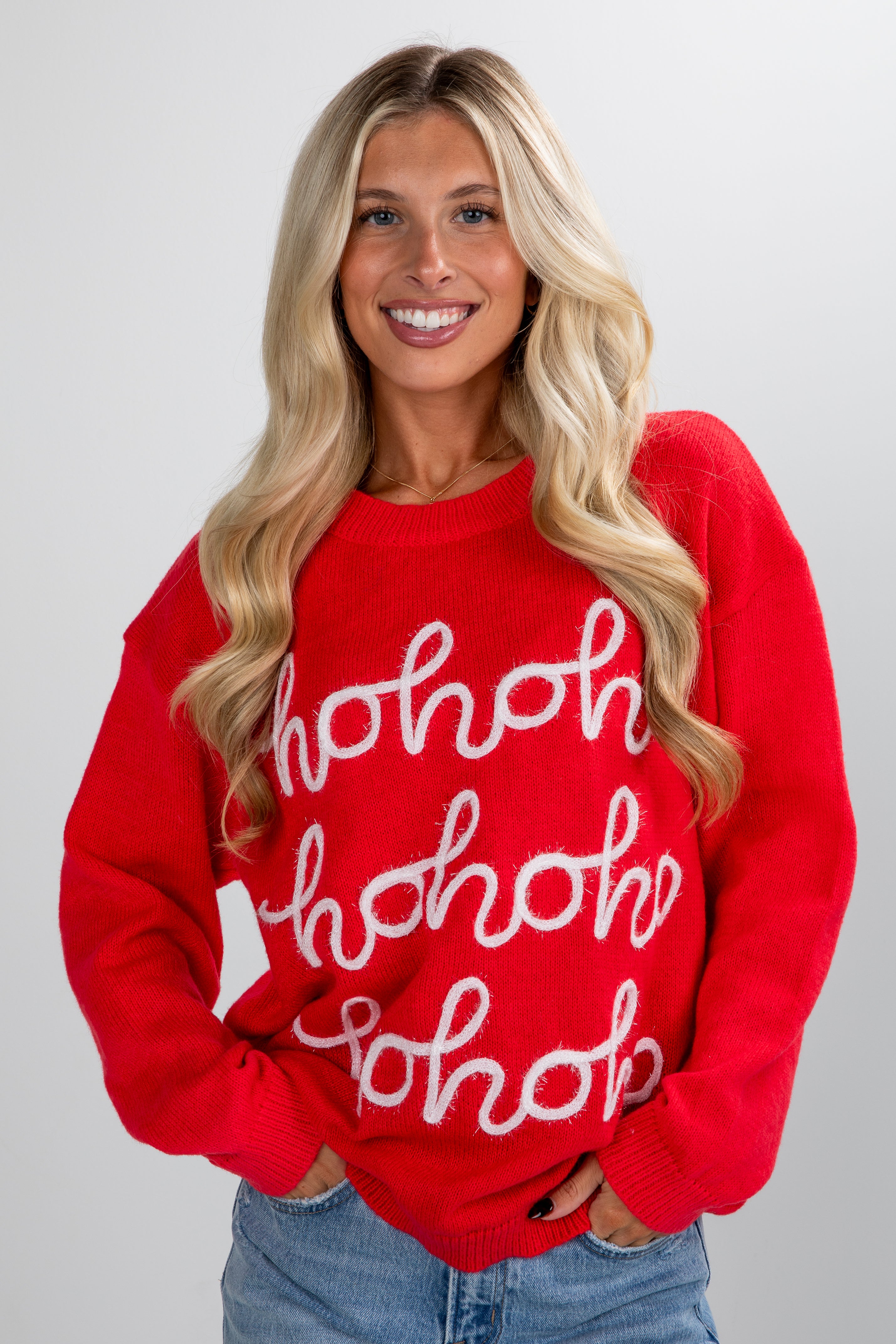 Woman wearing a red sweater with &