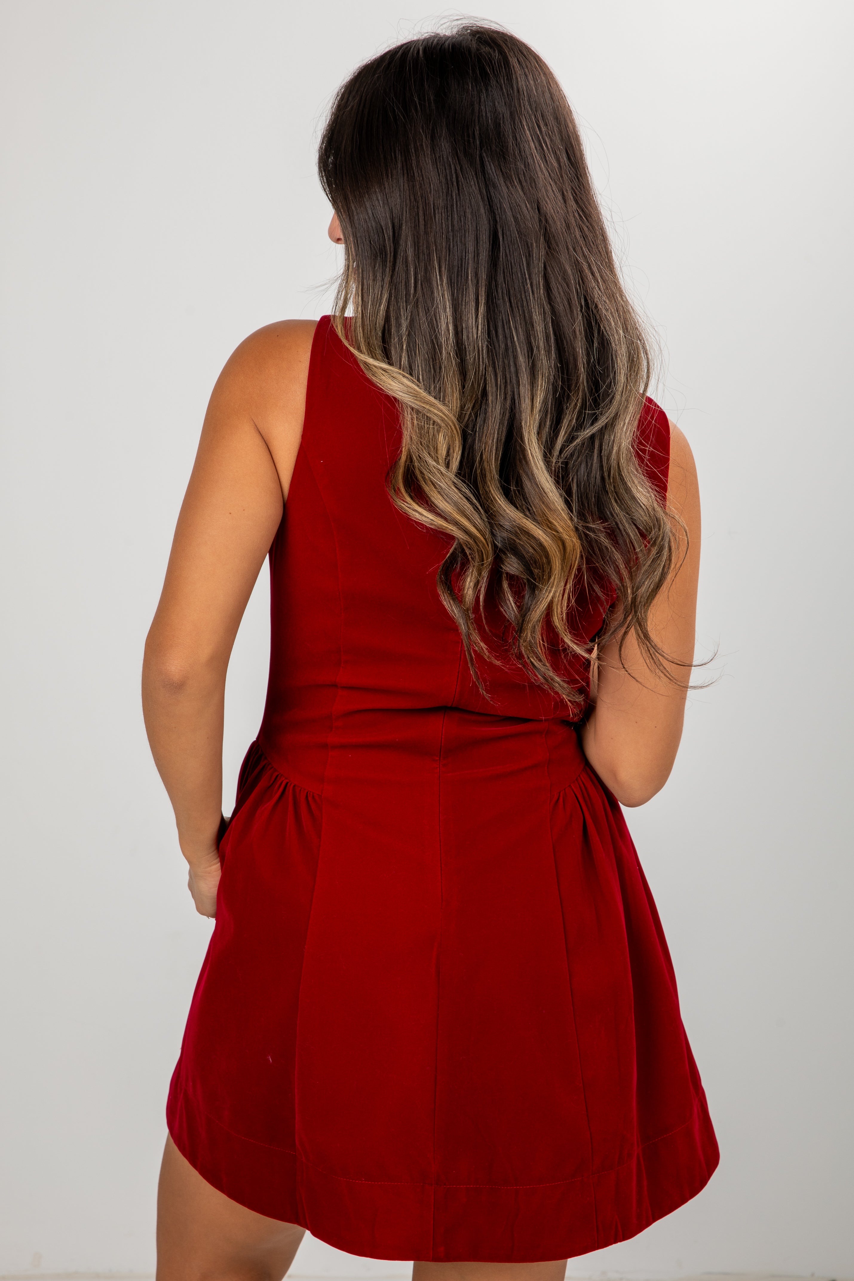 Red dress worn by a person on a white background
