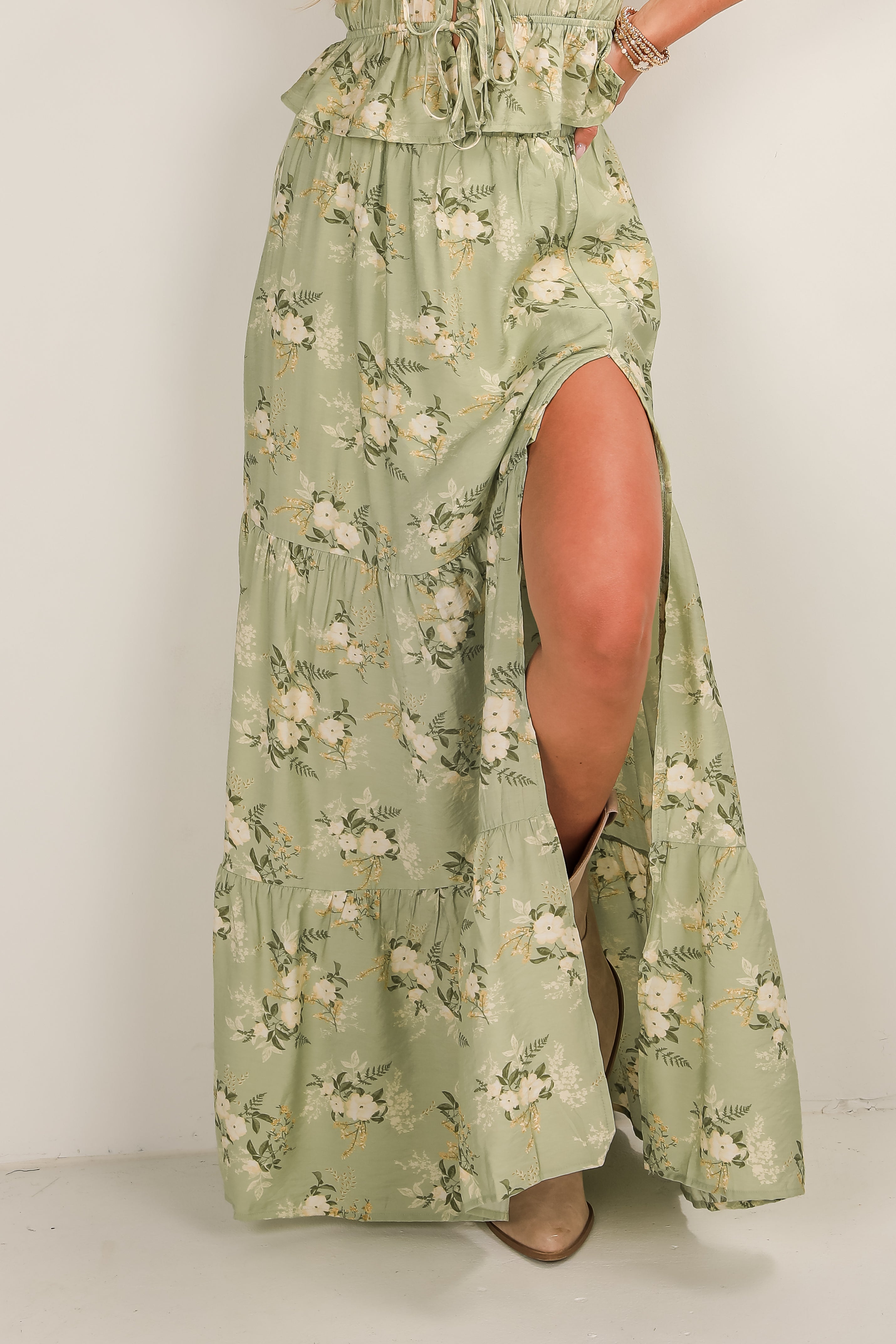 Green floral dress with a slit on a white background