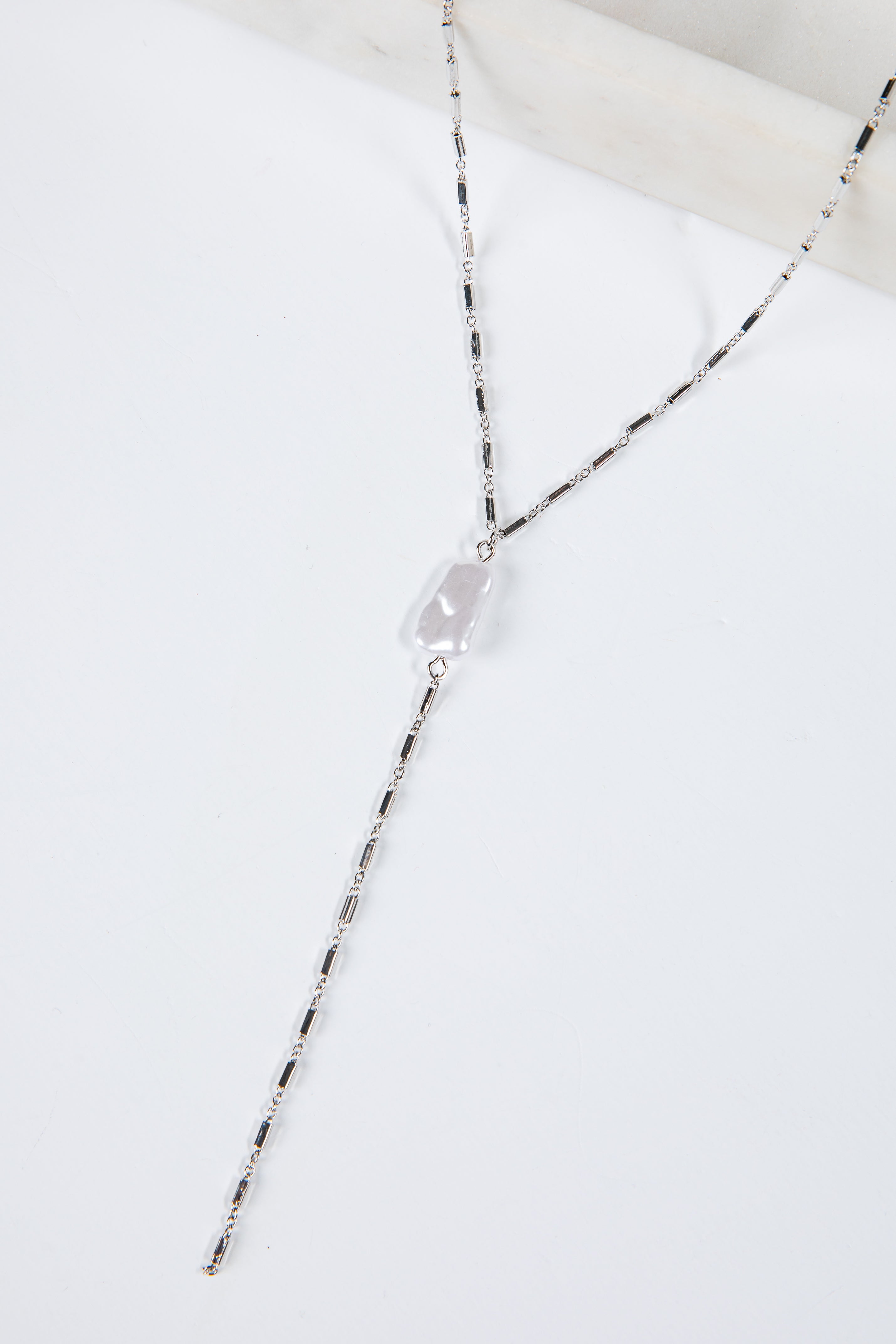 Necklace with a clear pendant on a white background