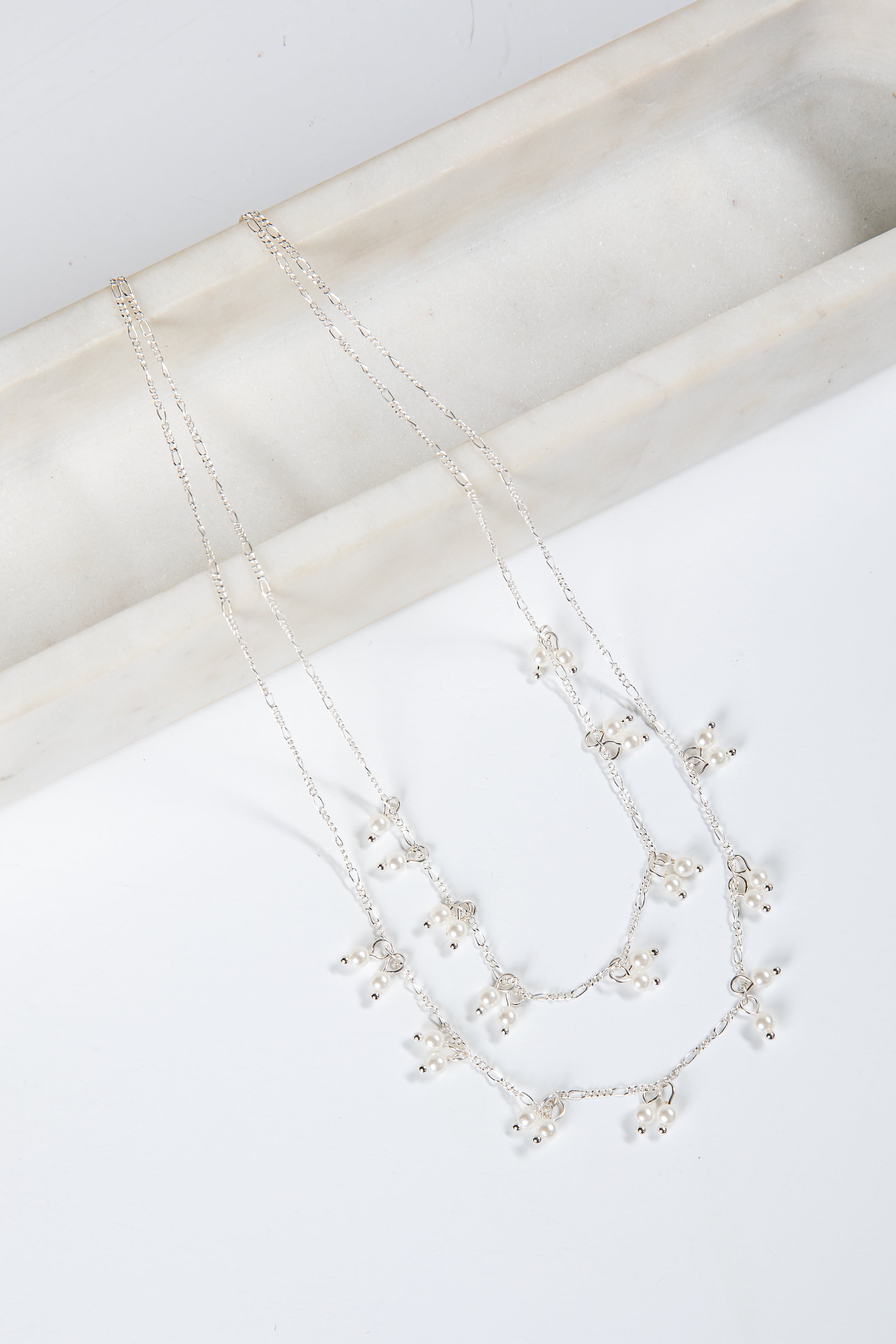 Necklace with small pearls on a white surface