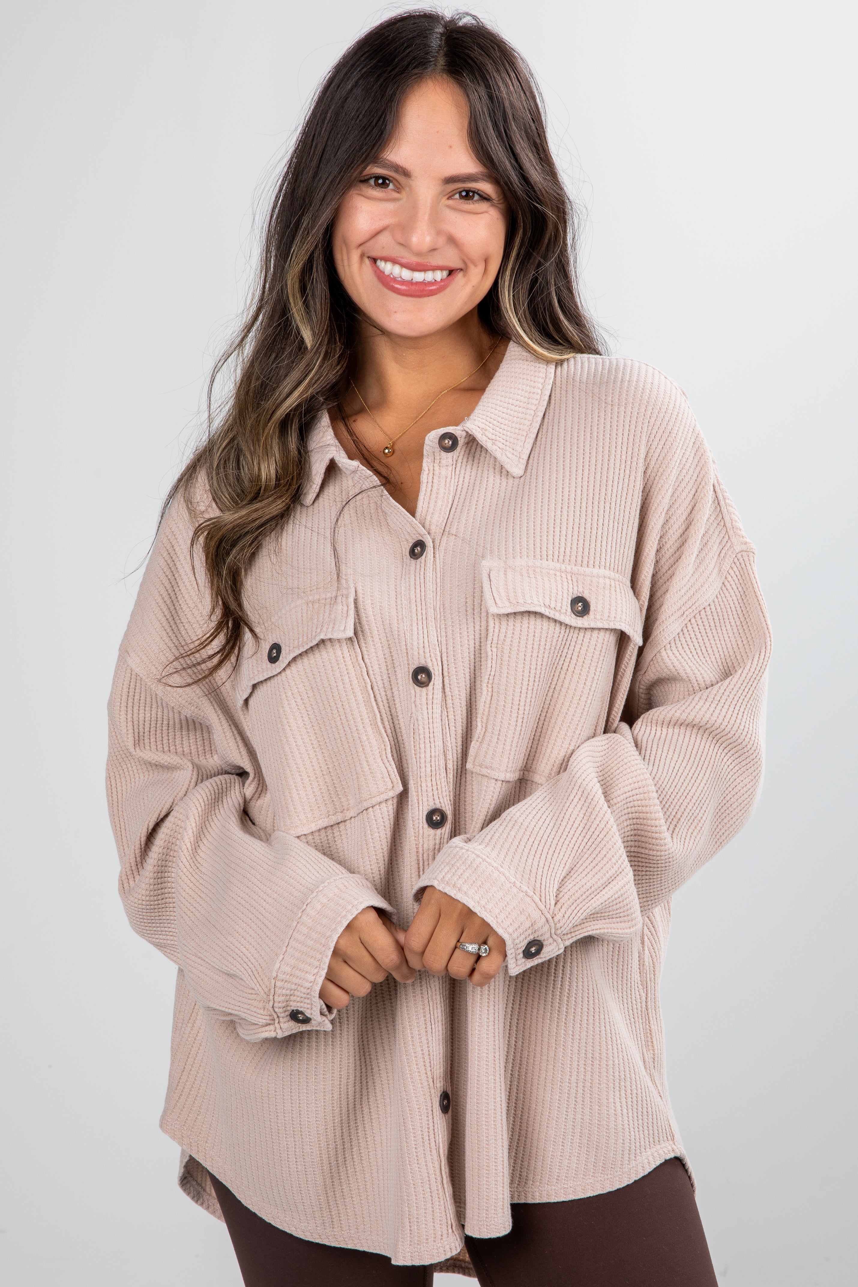 Woman wearing a beige corduroy shirt on a white background