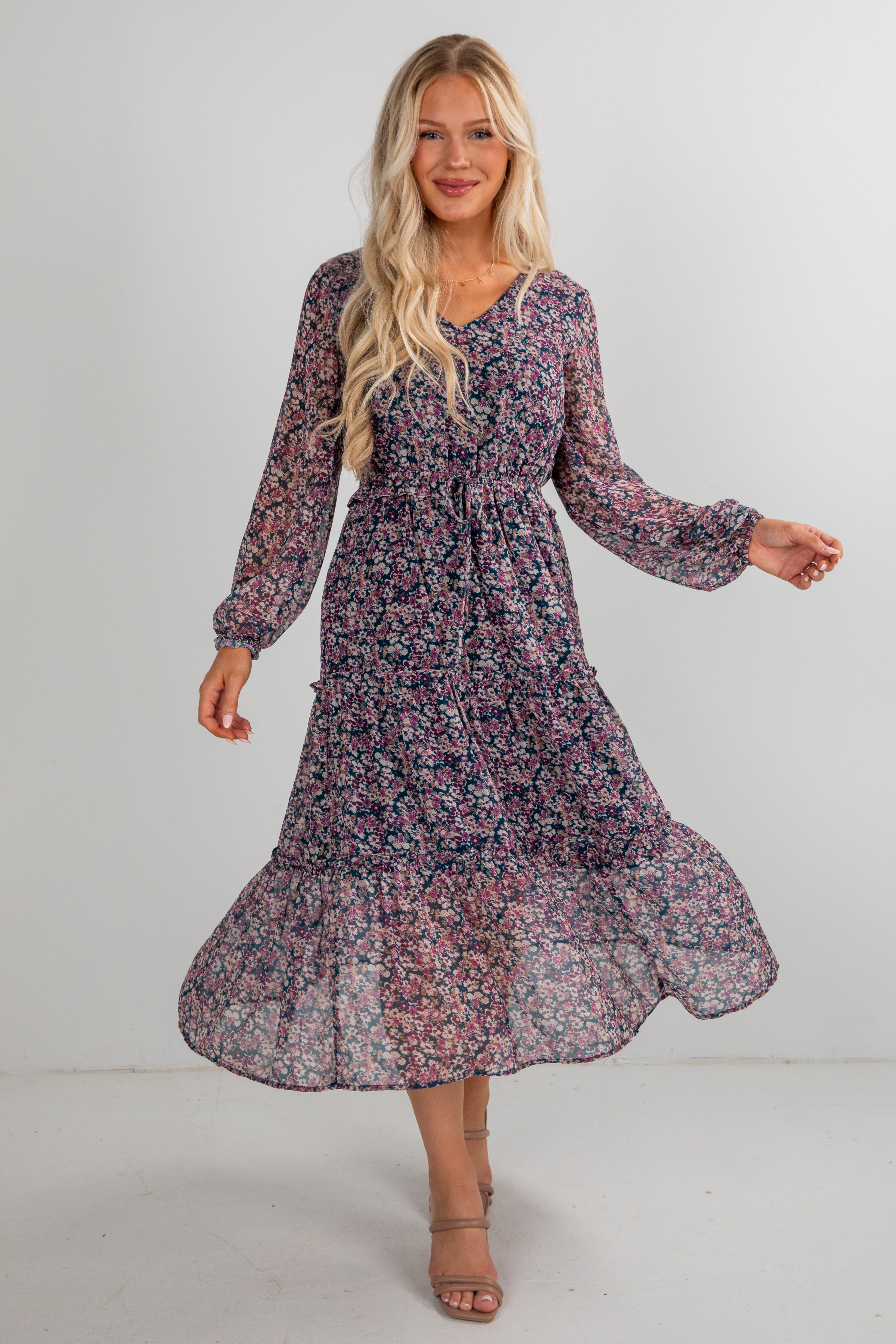 Woman wearing a floral dress on a plain background