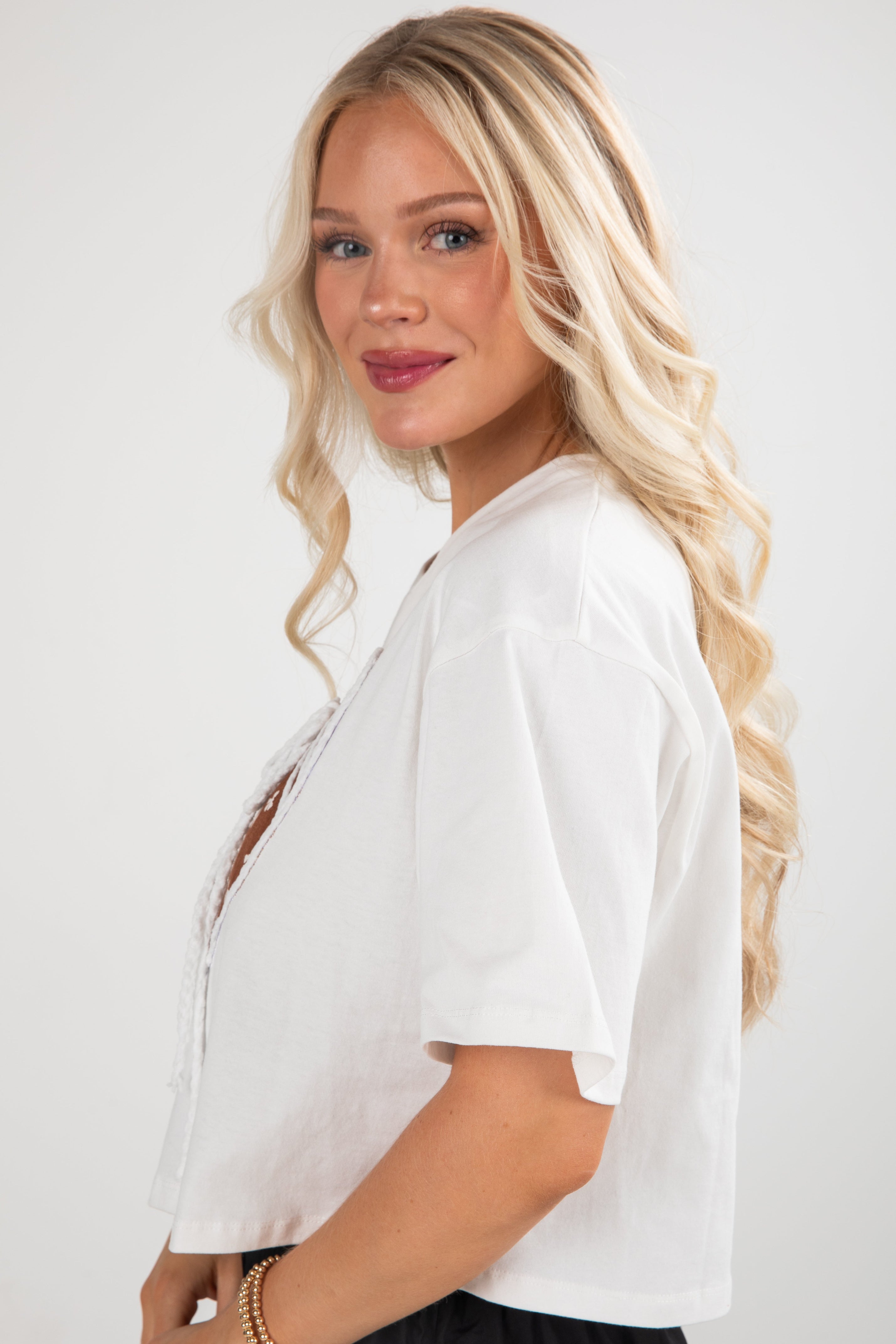 Woman wearing a white blouse with a plain background