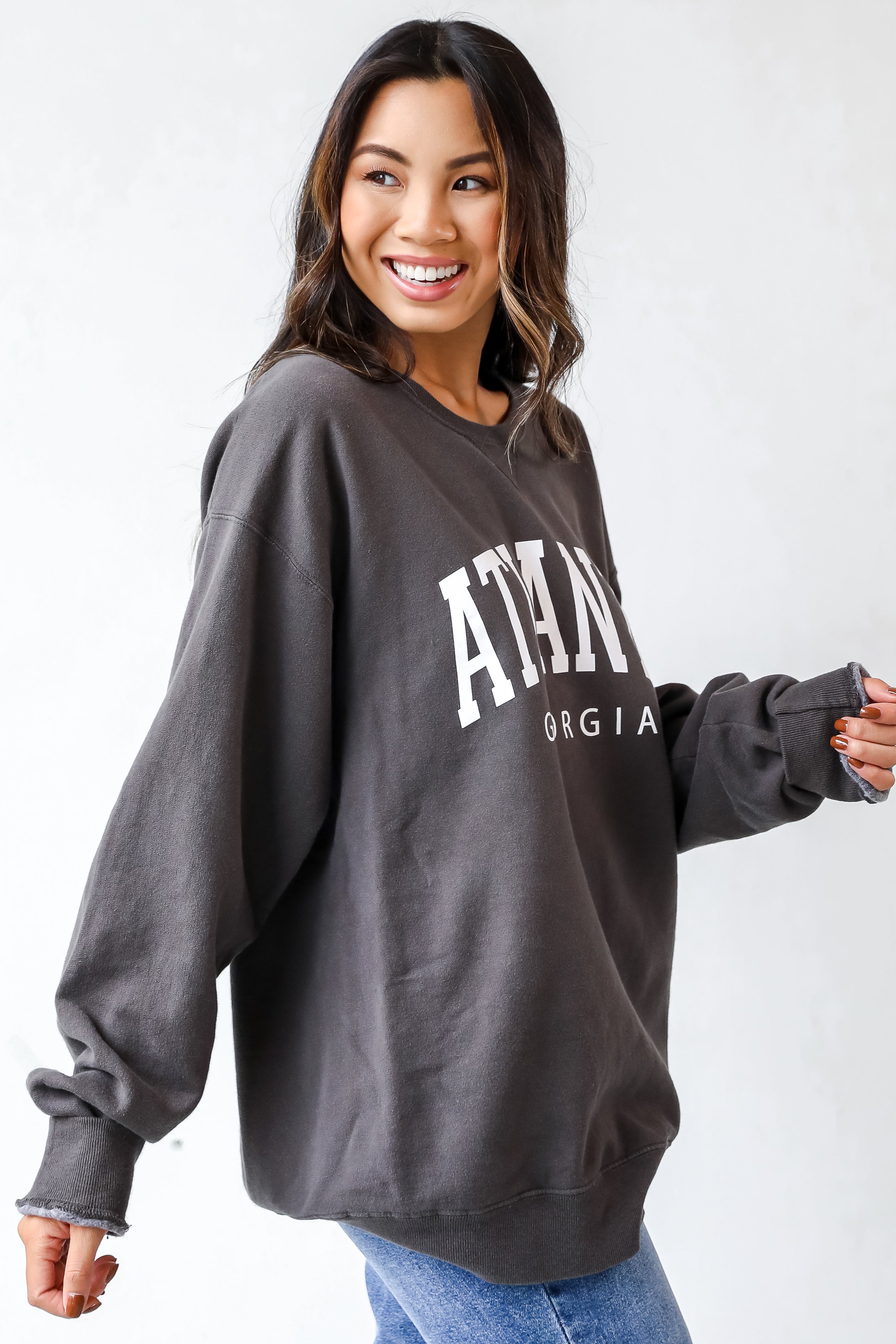 This comfy sweatshirt is designed with a soft and stretchy knit with a fleece interior. It features a crew neckline, long sleeves, a relaxed fit, and the words "Atlanta Georgia" on the front.