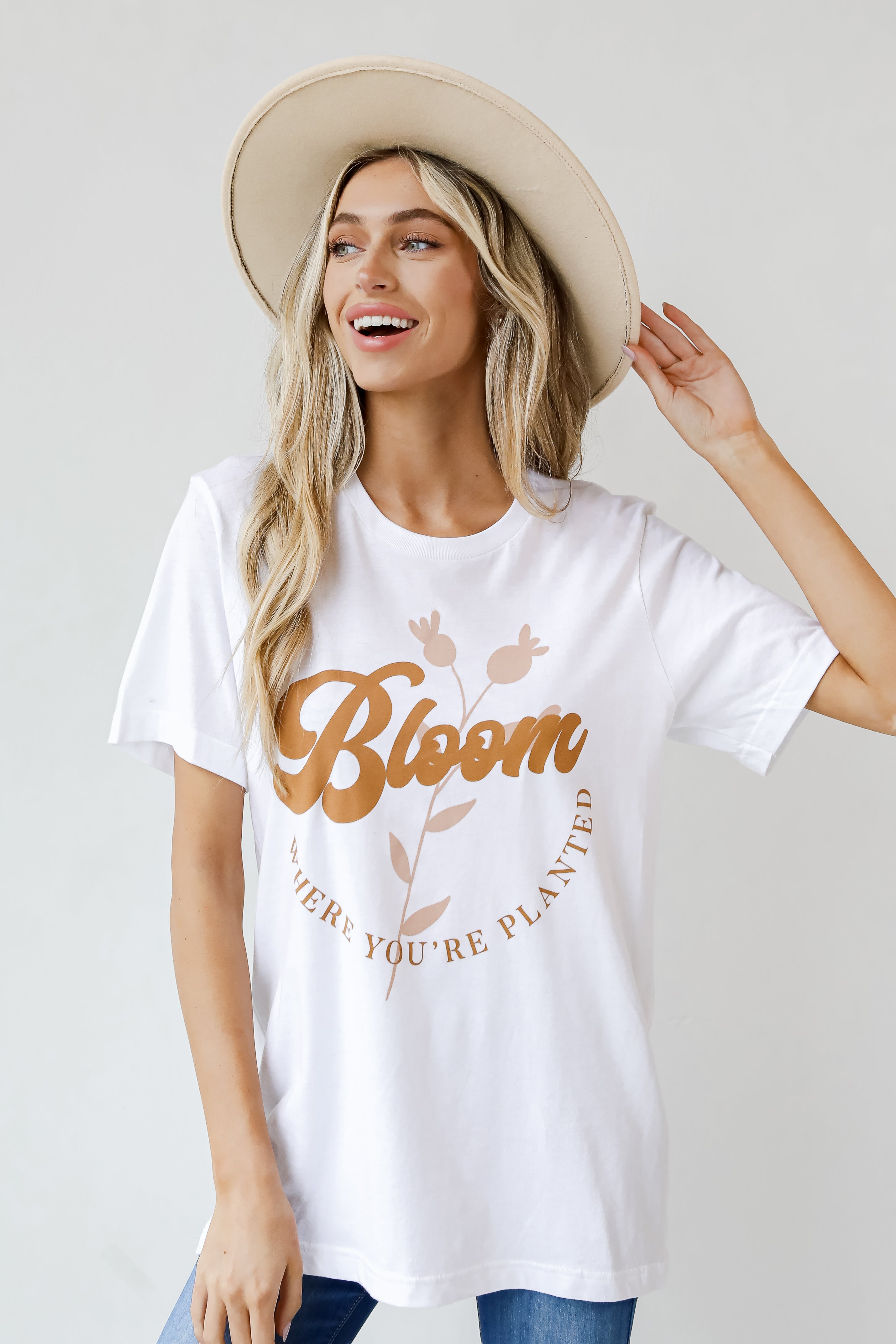 This comfy tee is designed with a soft and stretchy knit. It features a crew neckline, short sleeves, a relaxed fit, and the words "Bloom Where You&