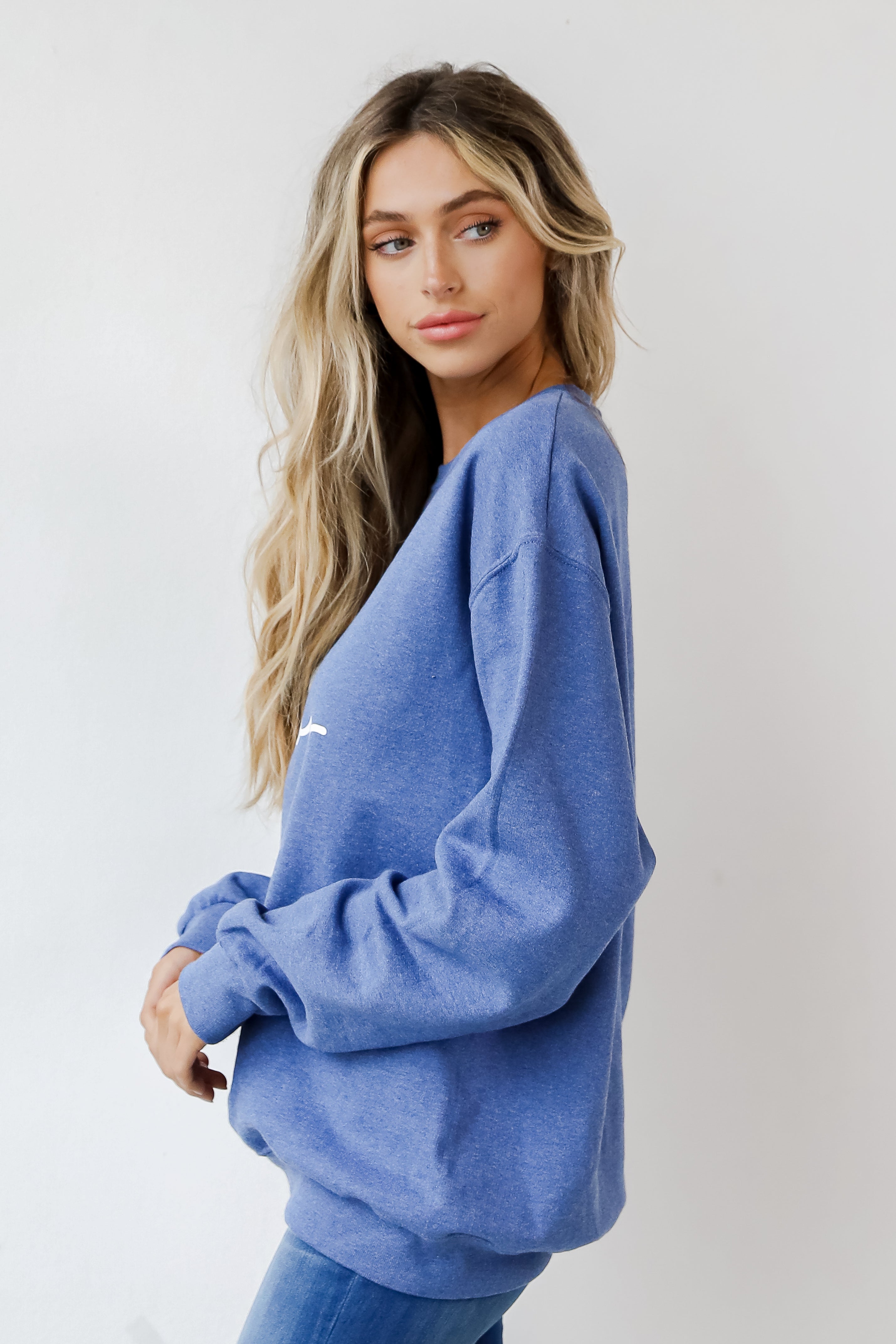 This comfy sweatshirt is designed with a soft and stretchy knit with a fleece interior. It features a crew neckline, long sleeves, a relaxed fit, and the words "Chop Chop" on the front.