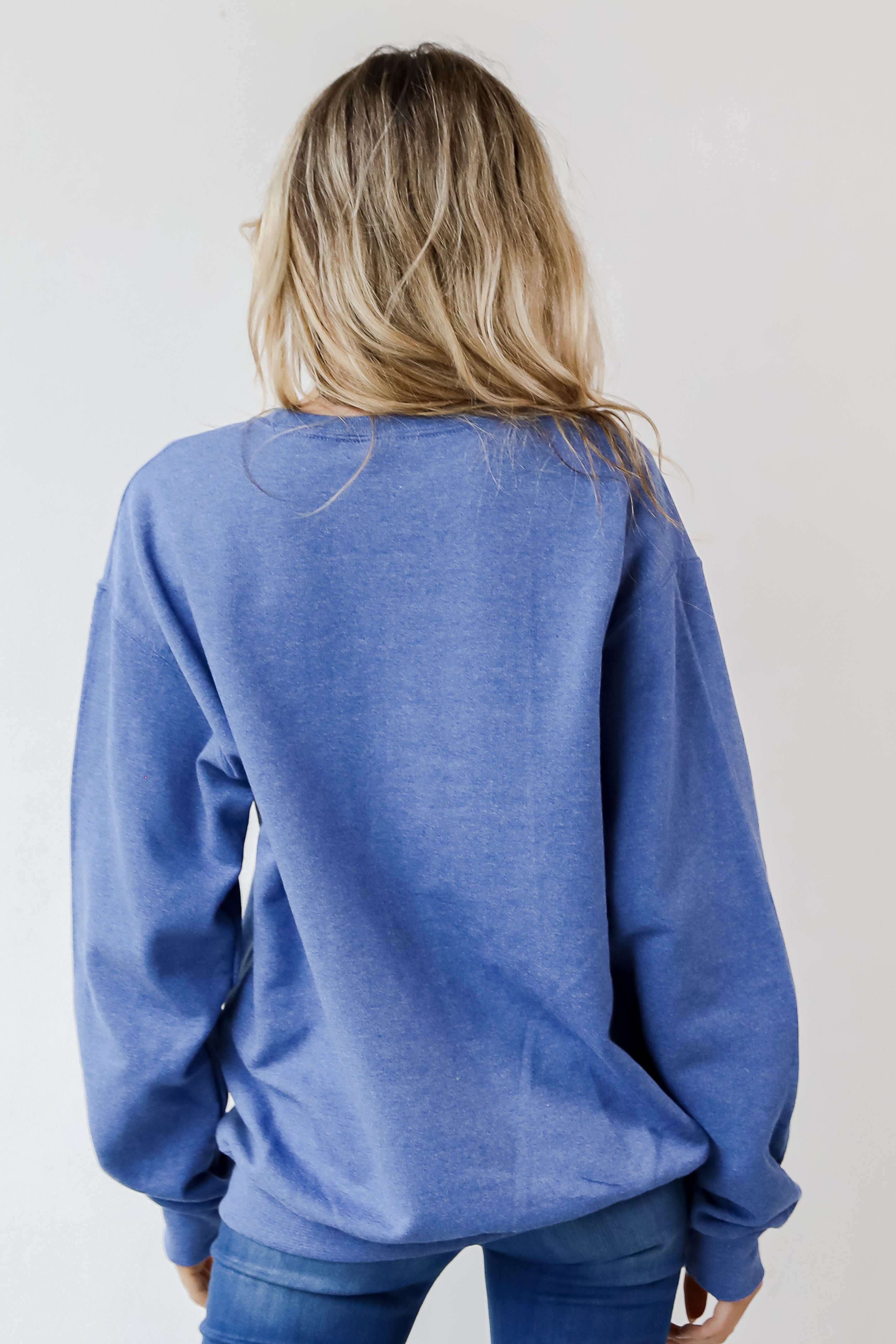 This comfy sweatshirt is designed with a soft and stretchy knit with a fleece interior. It features a crew neckline, long sleeves, a relaxed fit, and the words "Chop Chop" on the front.
