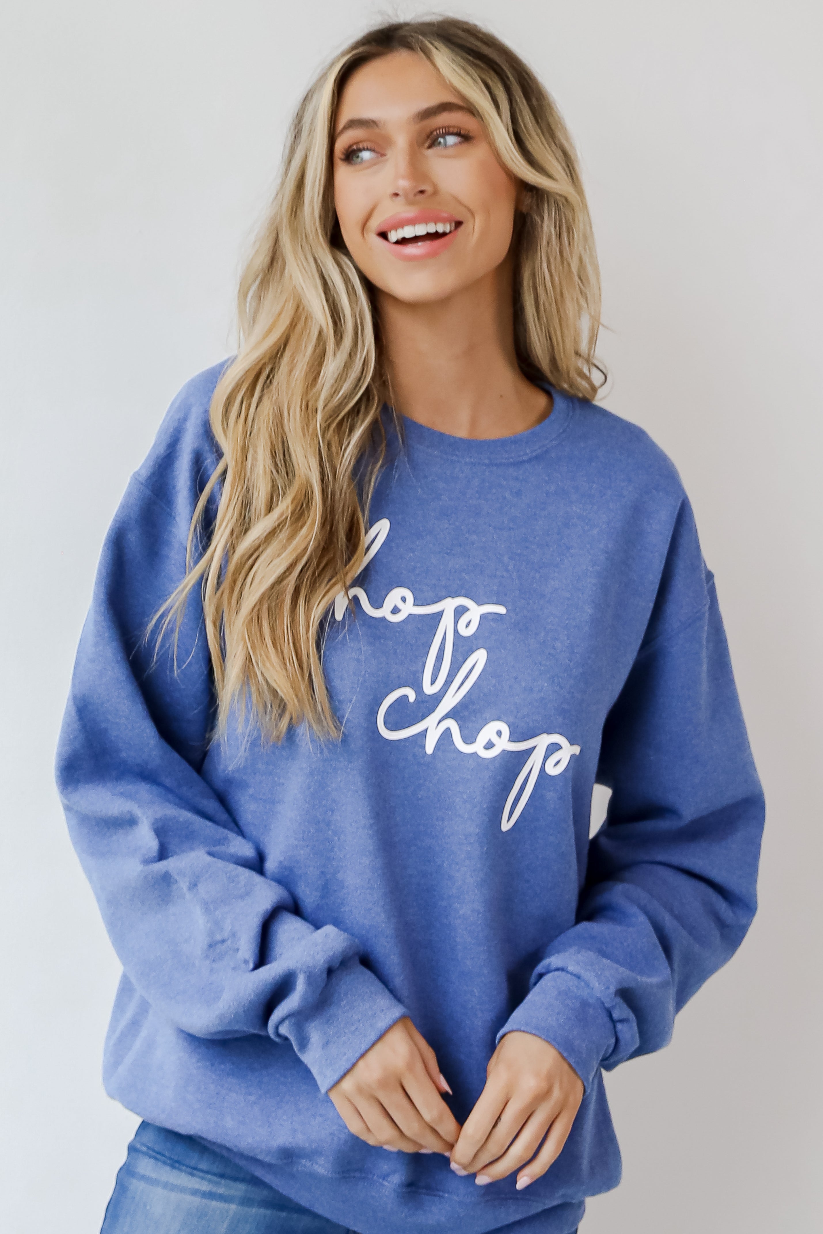 This comfy sweatshirt is designed with a soft and stretchy knit with a fleece interior. It features a crew neckline, long sleeves, a relaxed fit, and the words "Chop Chop" on the front.