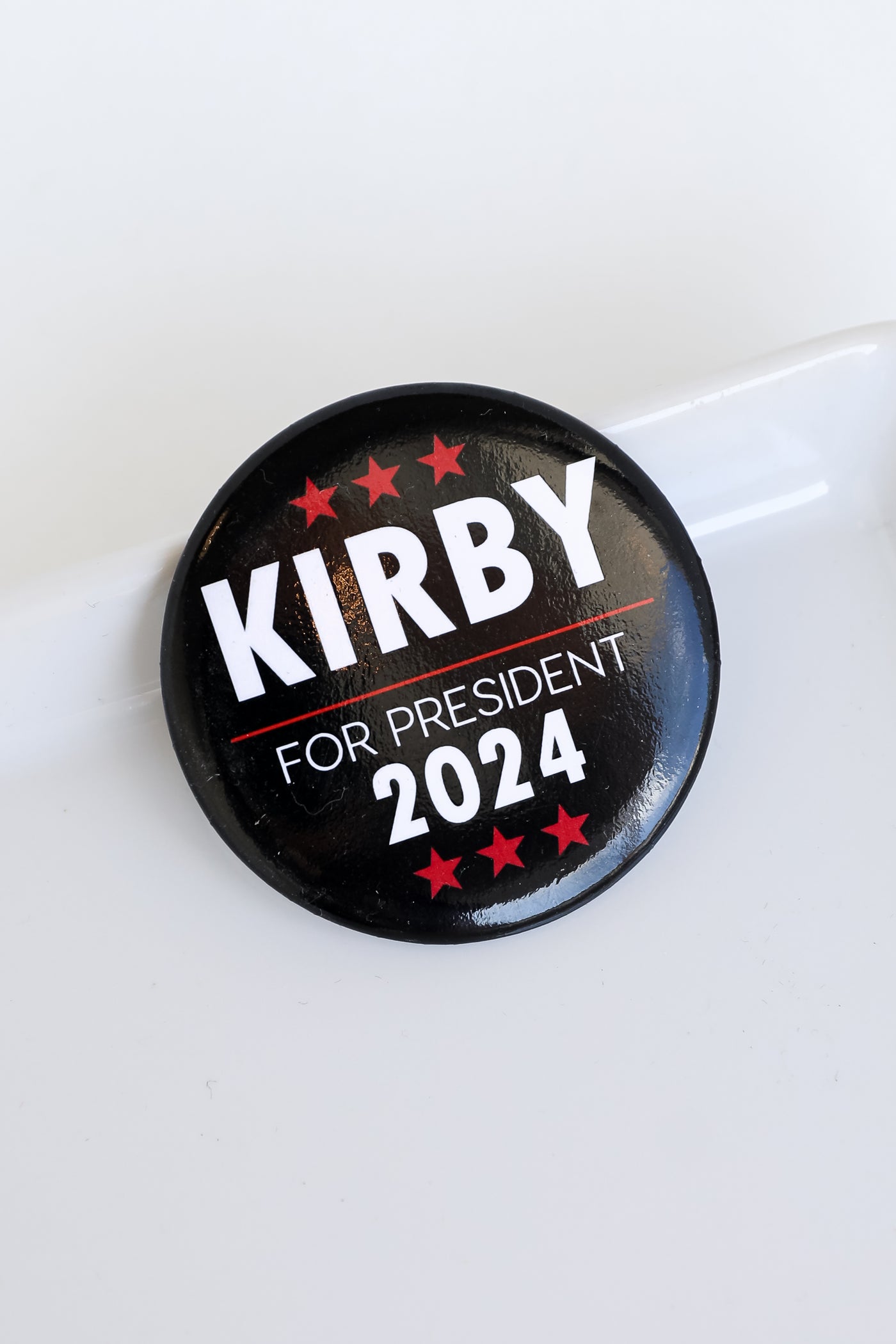 black Kirby For President Button flat lay