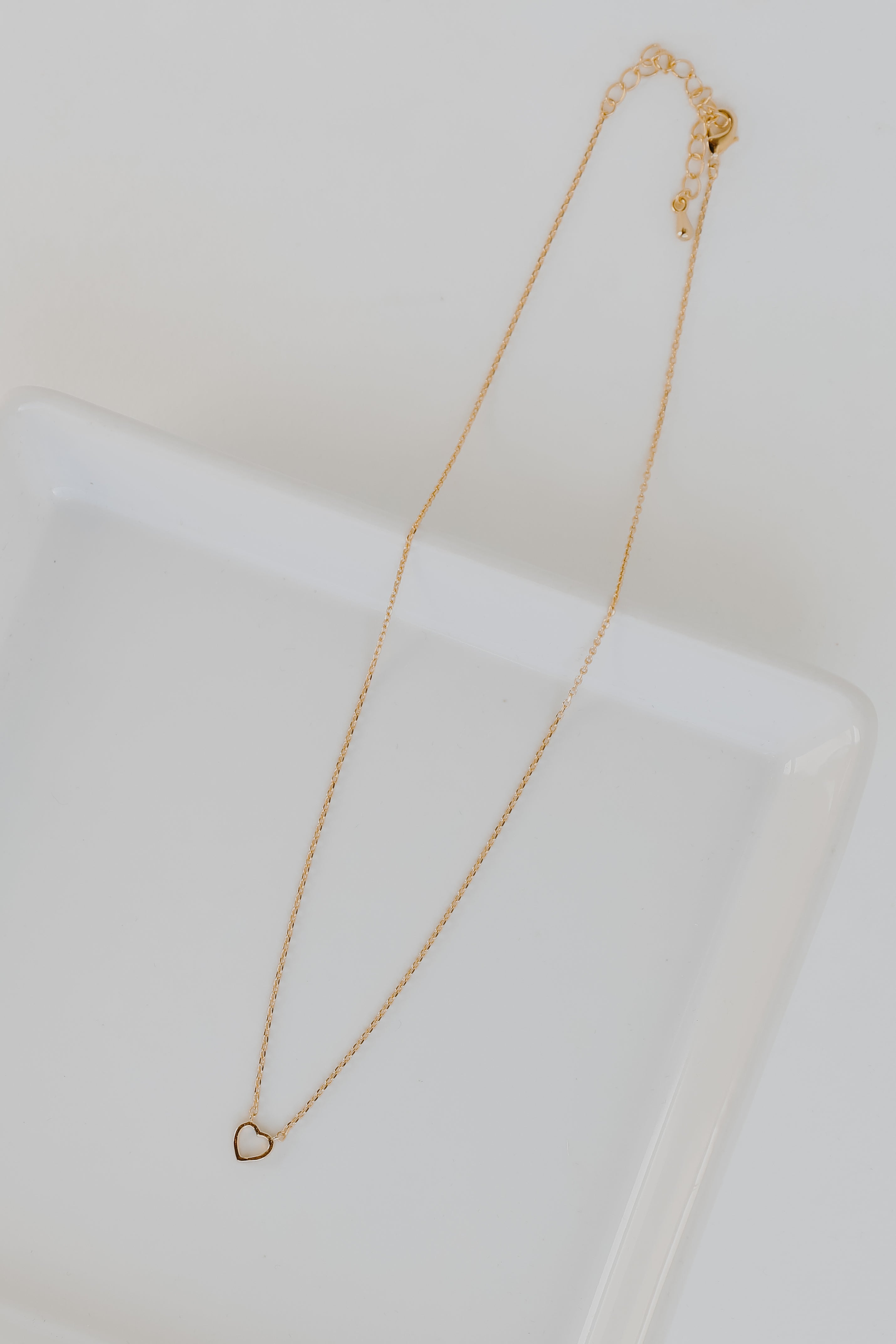 Gold Heart Charm Necklace flat lay