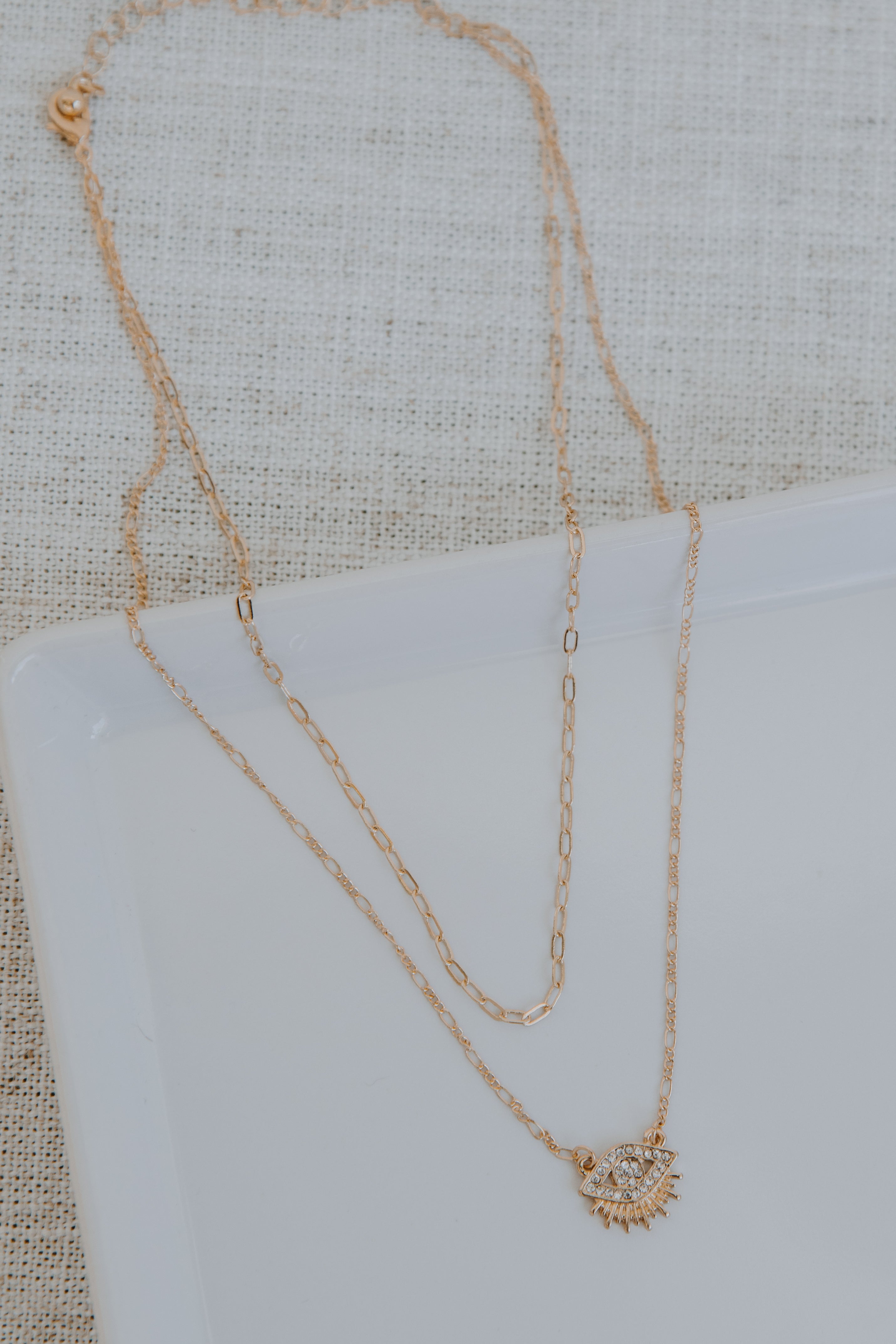 Gold Rhinestone Eye Layered Necklace flat lay