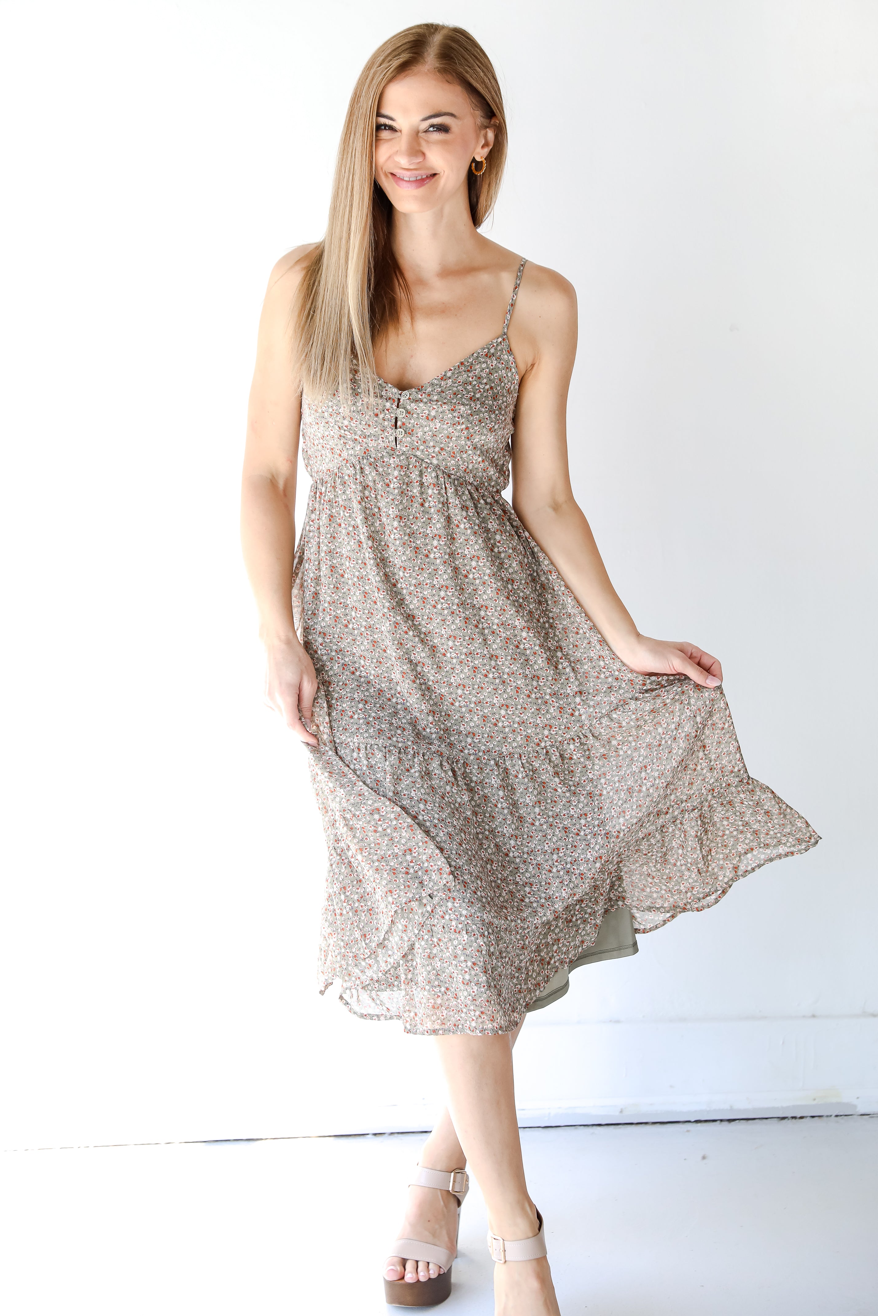 model wearing a floral midi dress with heels