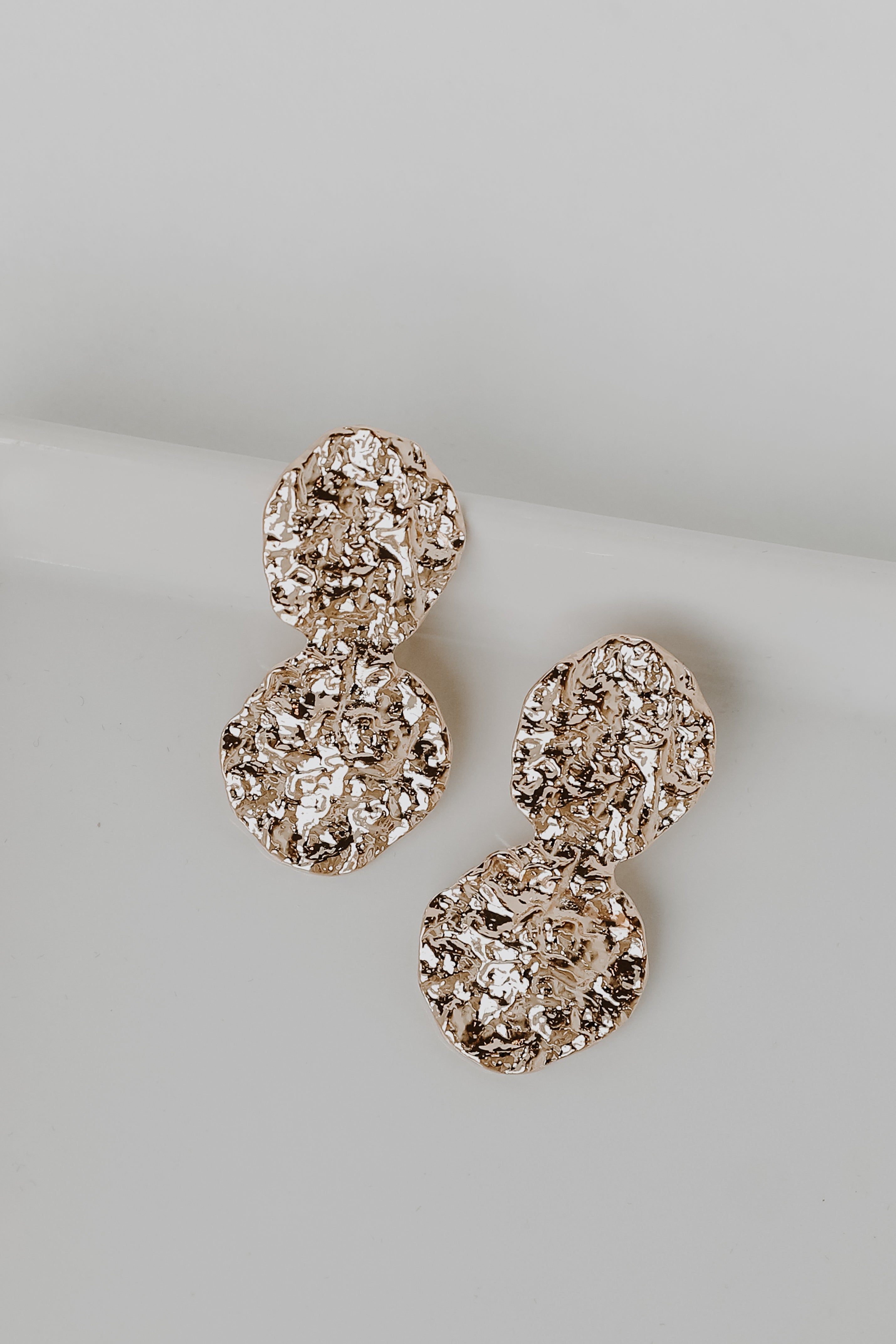 Gold Hammered Drop Earrings flat lay