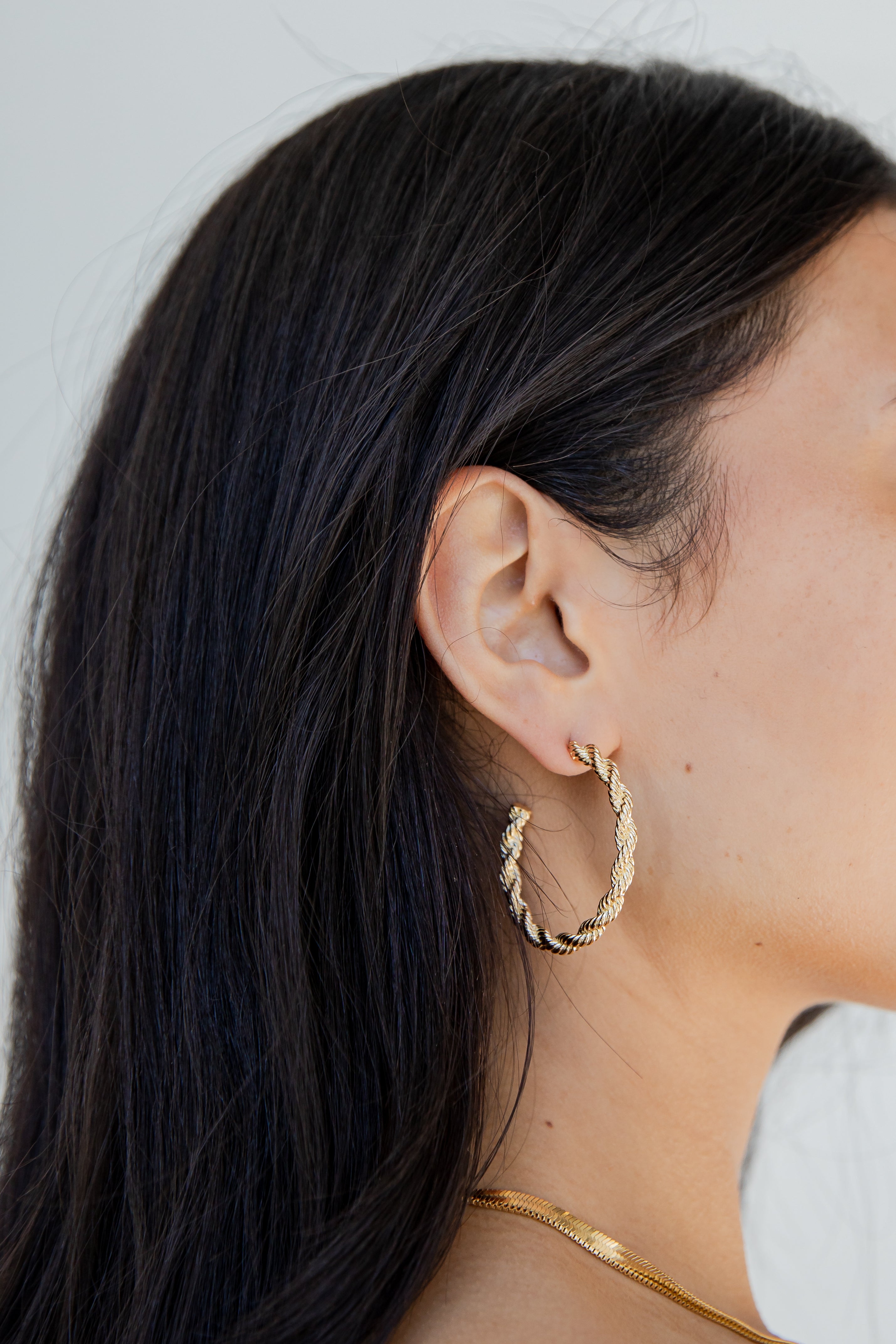 Gold Twisted Hoop Earrings on model